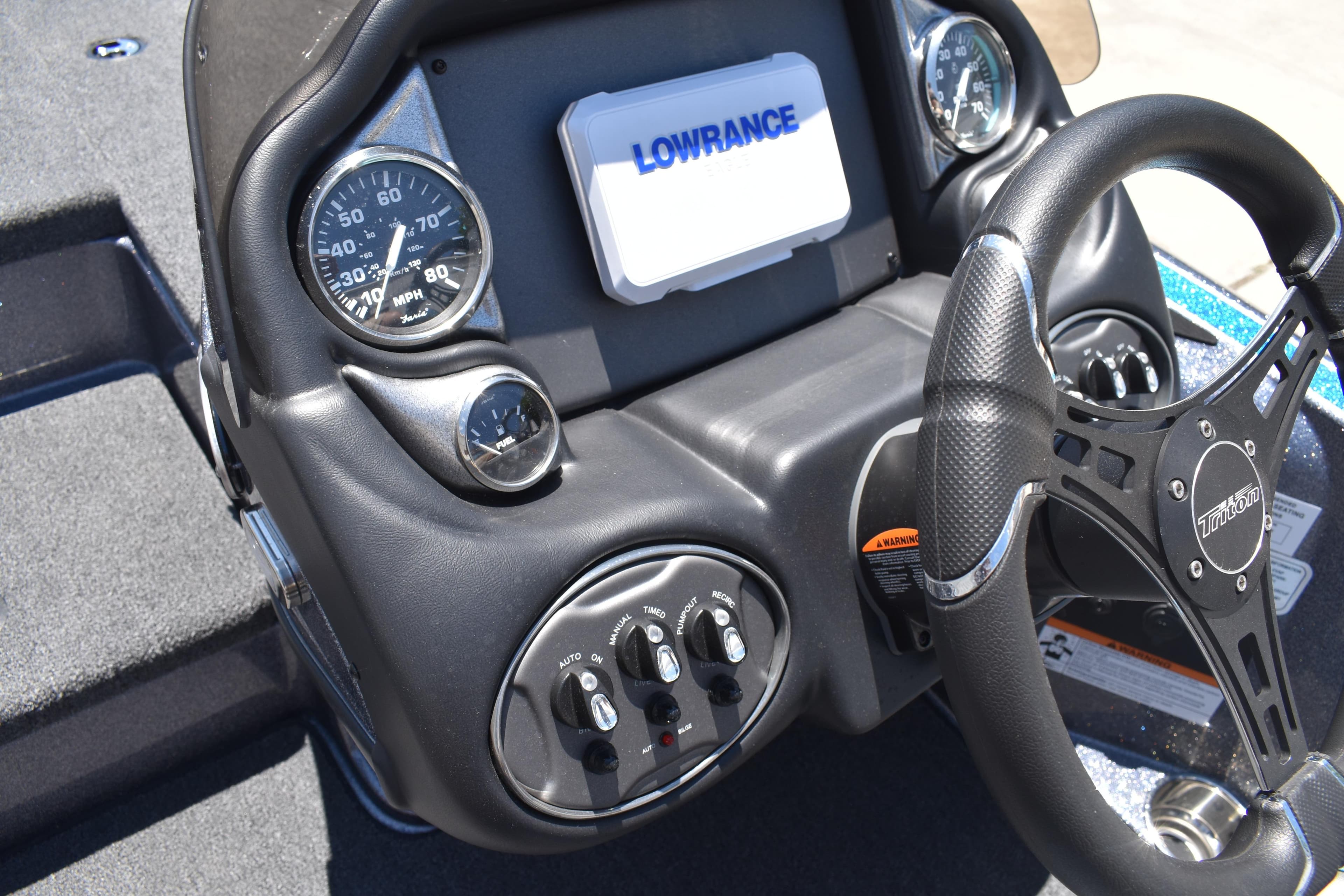 Dashboard of 2026 Triton 179 TrX boat with steering wheel and gauges.