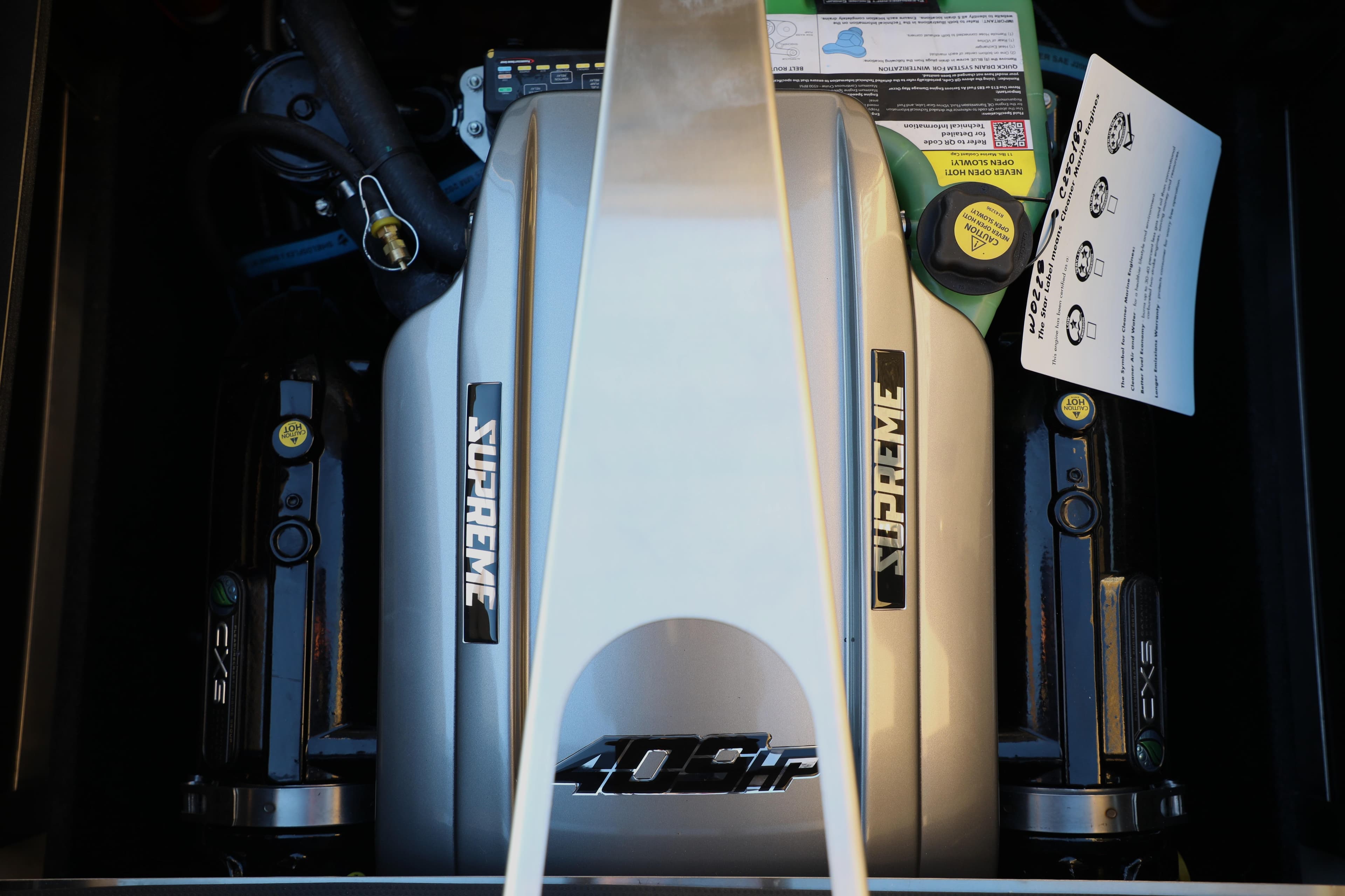 Engine of 2026 Supreme S220 boat, featuring 409 horsepower branding.