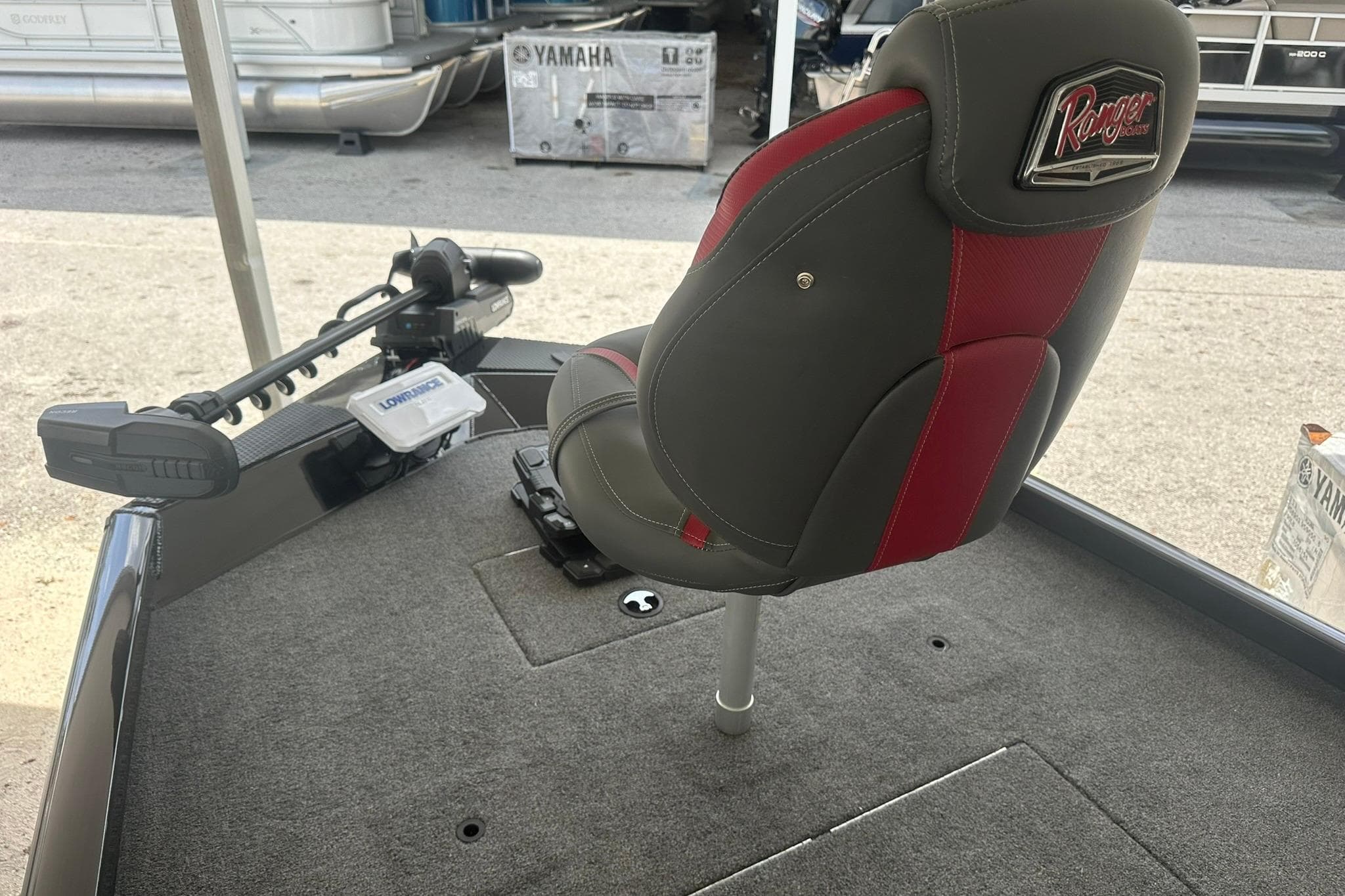 2025 Ranger RT188C boat interior with a red and gray seat and trolling motor.