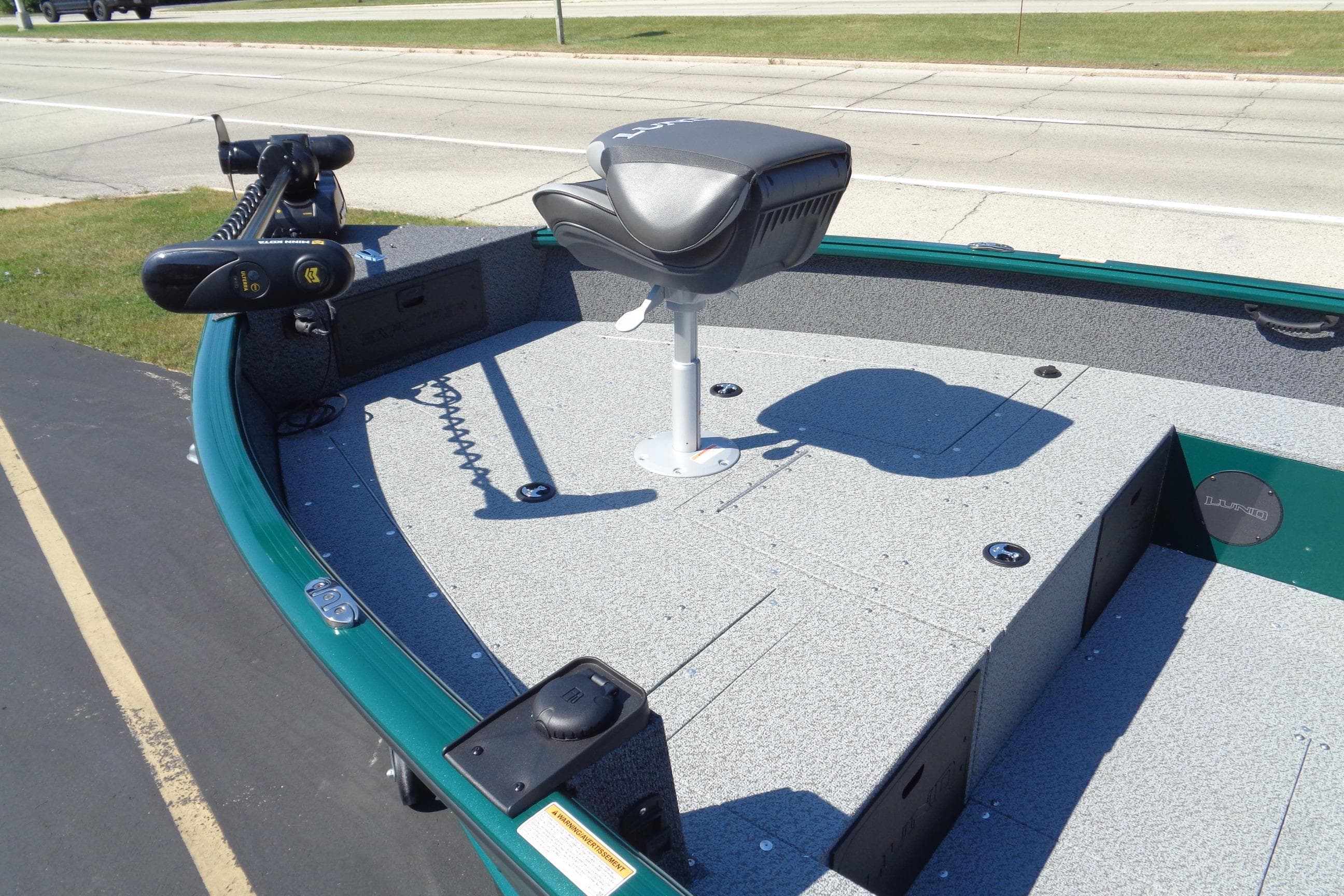 2026 Lund 1800 Explorer Tiller boat deck with seat and trolling motor.
