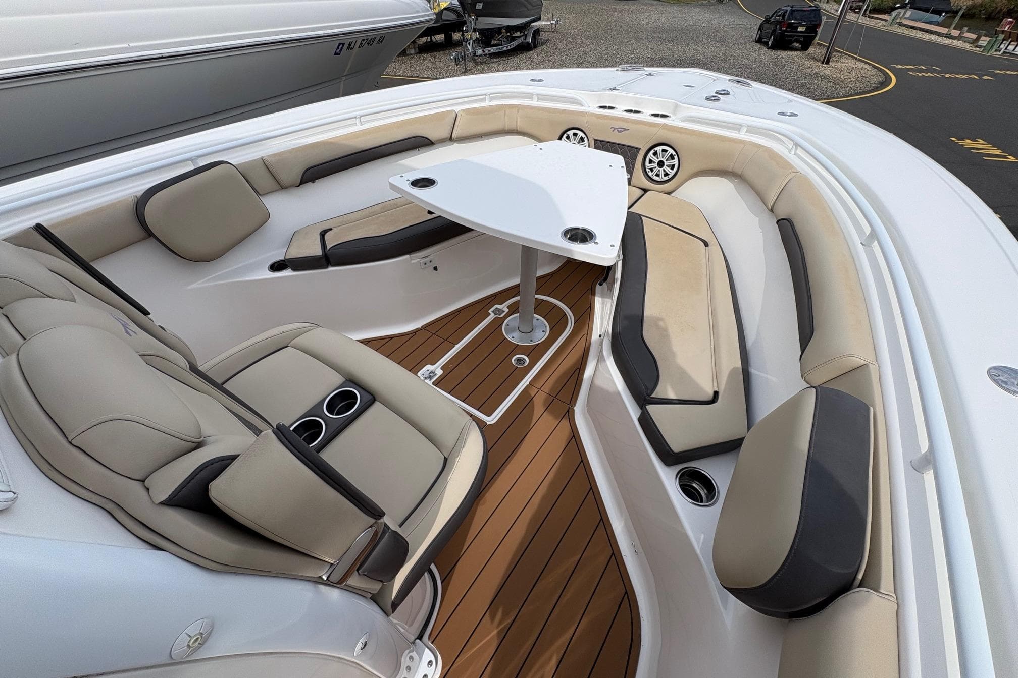 2018 Tidewater 280 CC Adventure boat interior with cushioned seating and table.