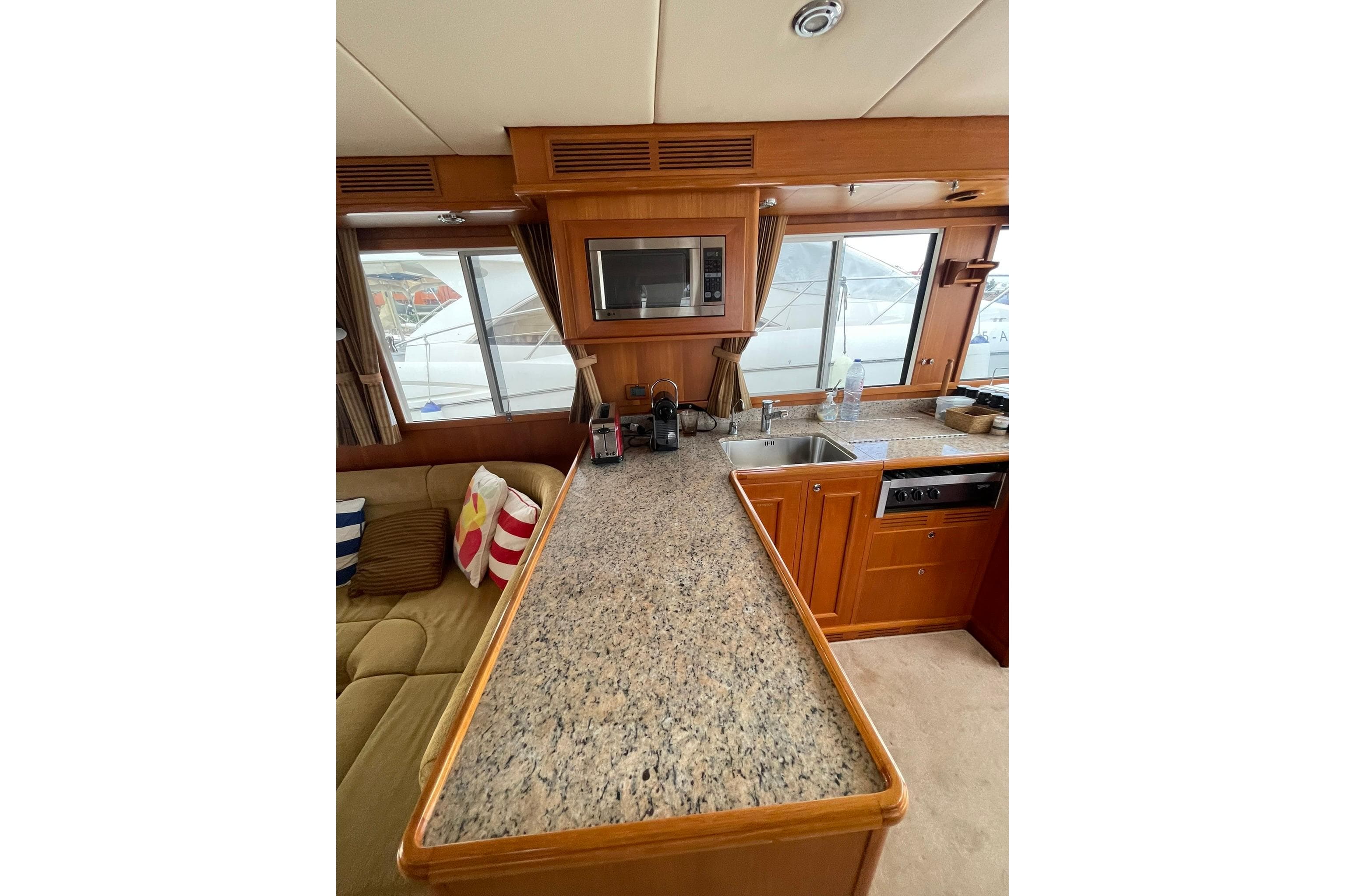 2008 Grand Banks 47 Heritage EU yacht interior with kitchen and seating area.