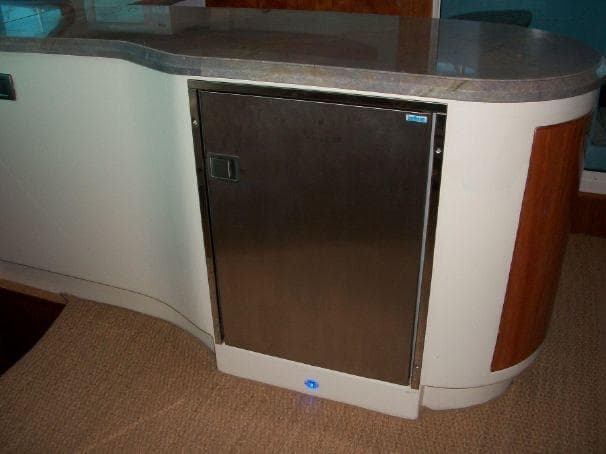 Modern kitchen area in a 2009 Prout 45S yacht, featuring sleek cabinetry and countertop.