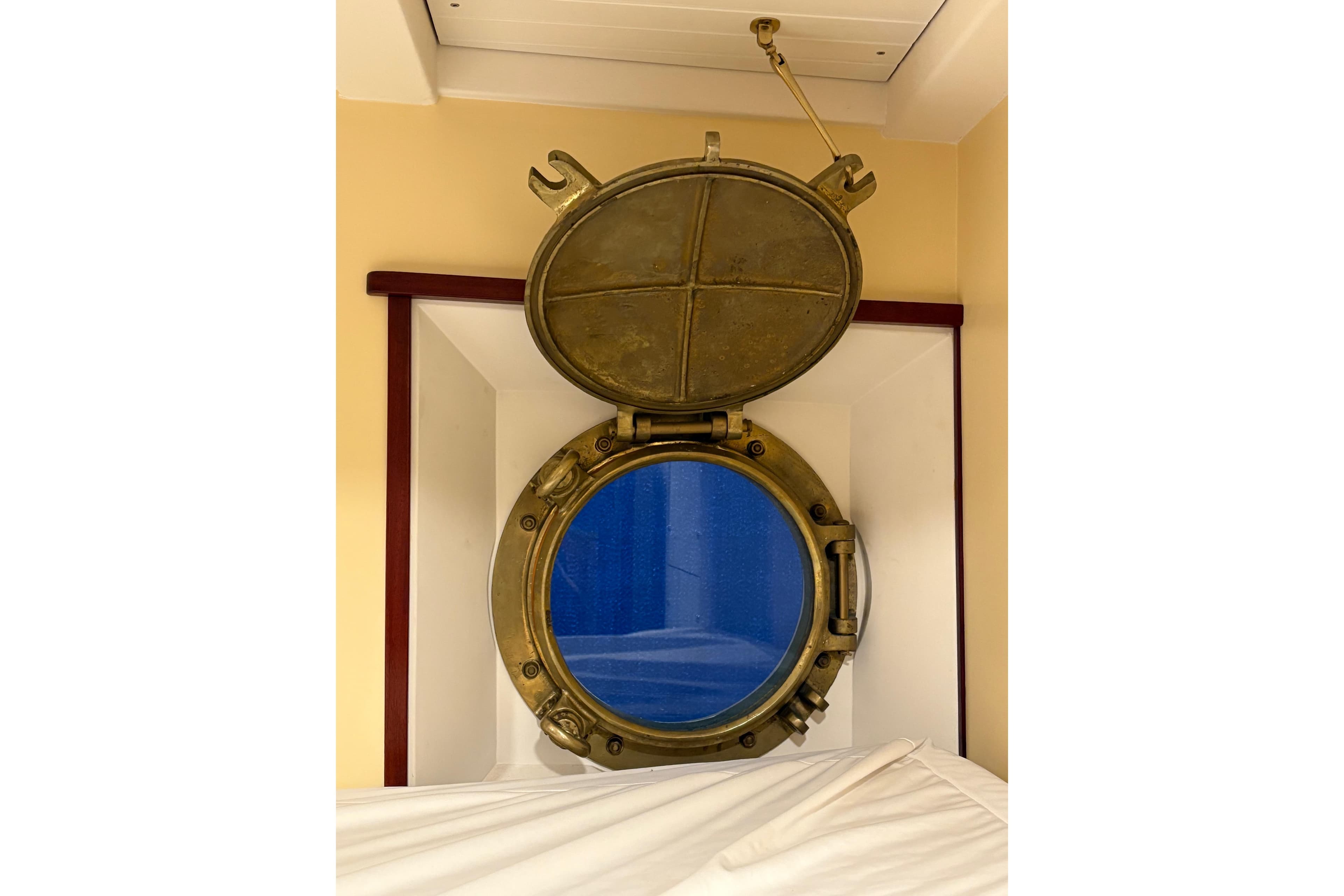 Open brass porthole on 1941 McKenzie Barge & Derrick Co. Ltd Tug, interior view.