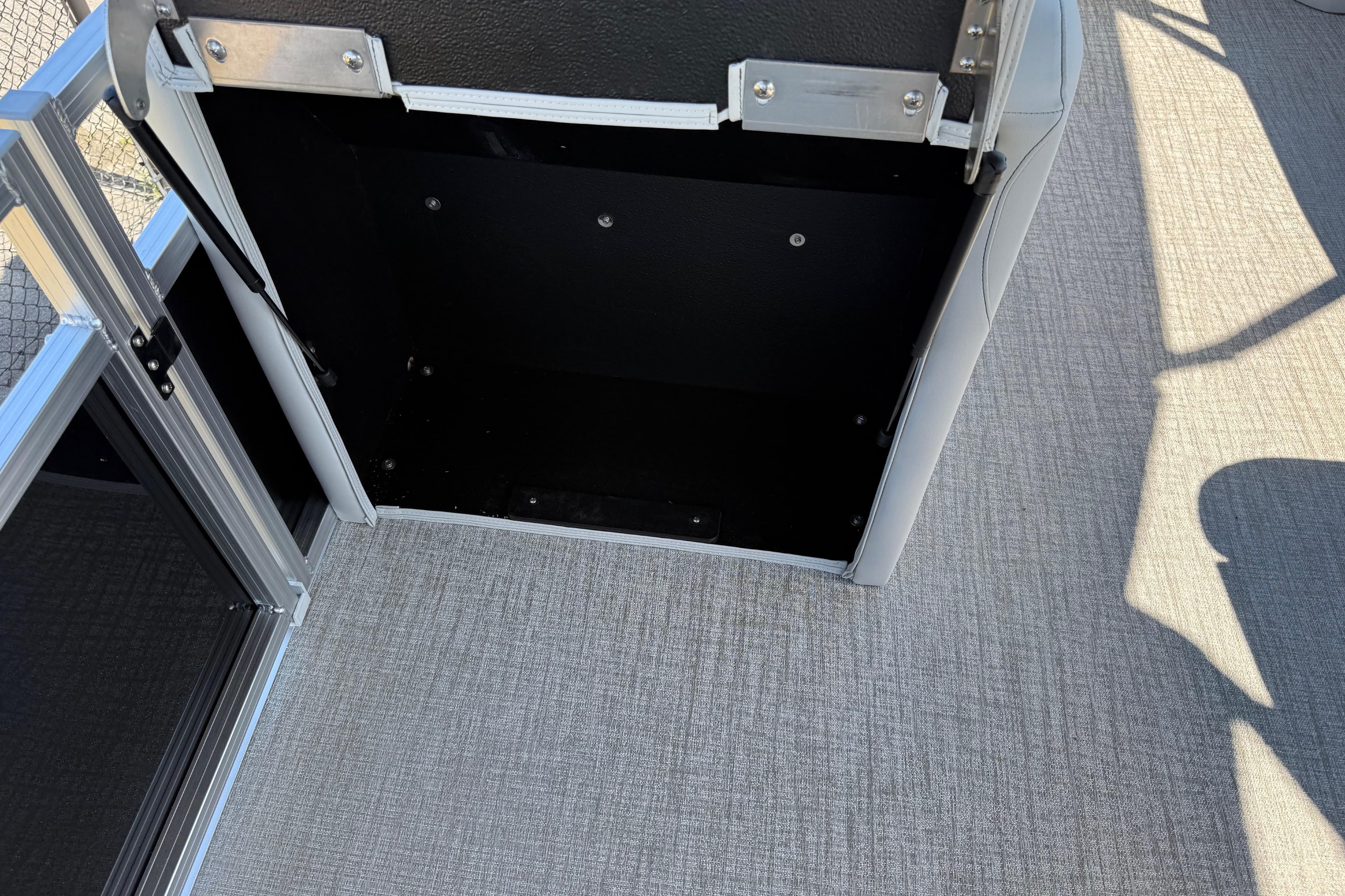 Open storage compartment in 2026 Avalon Venture 85 Versatile rear bench, showcasing interior space.