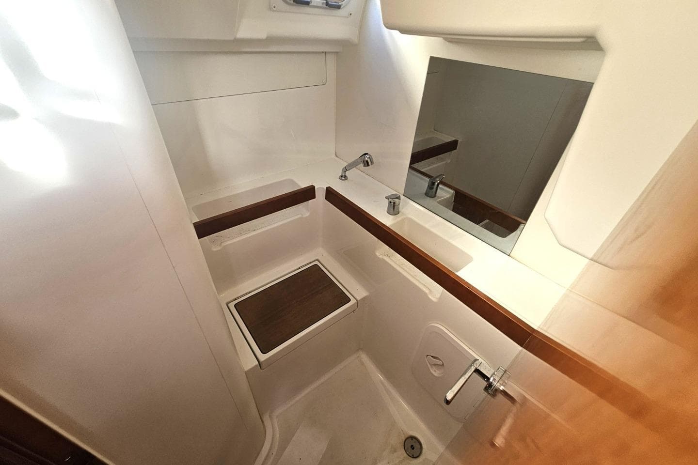 Bathroom interior of 2016 Beneteau Oceanis 35 yacht, featuring sink and mirror.