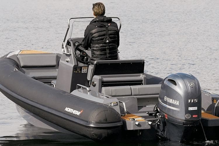 2026 Northstar Orion 6 boat with Yamaha 115 engine on calm water.