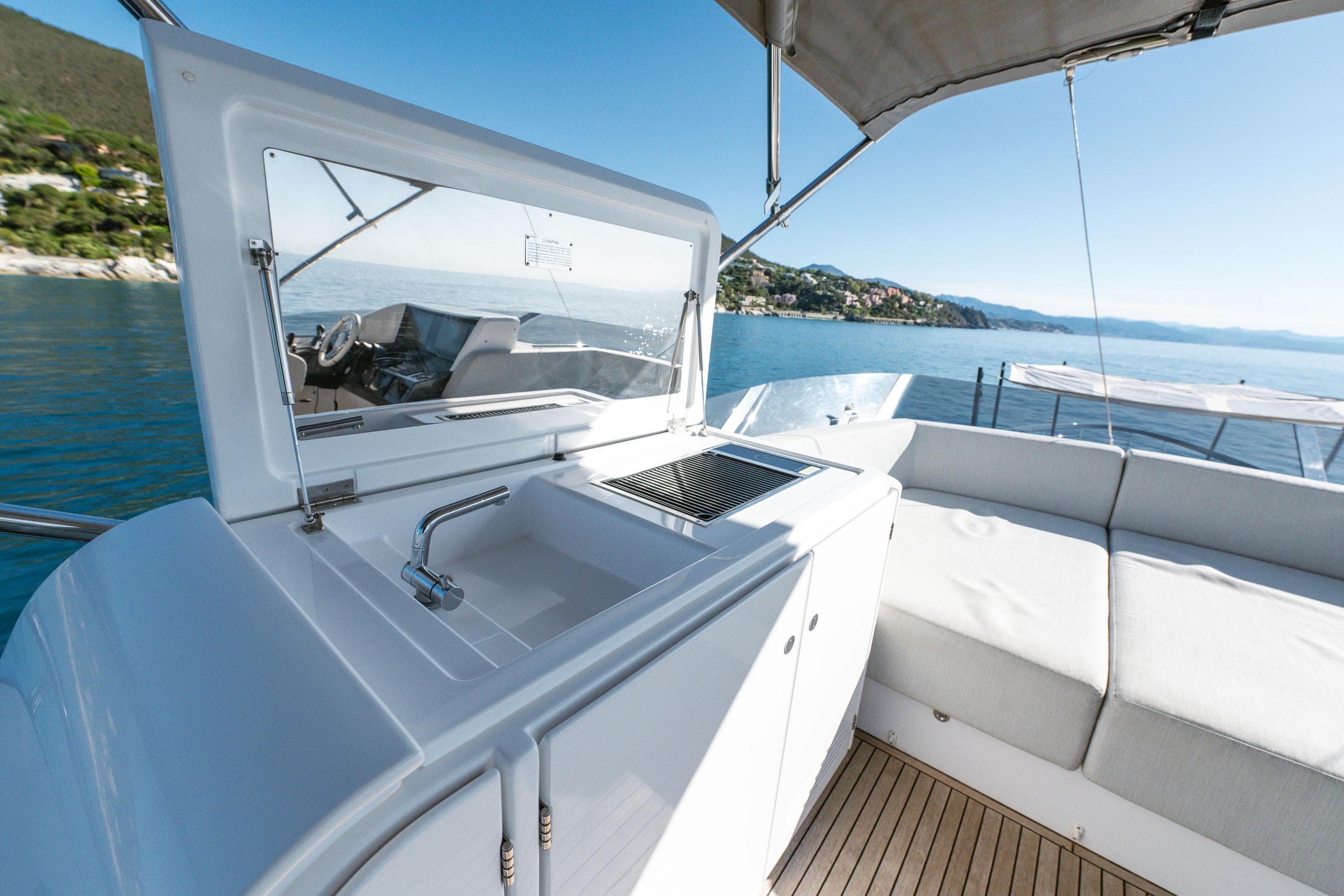 Luxurious 2020 Azimut S8 yacht deck with sink, seating, and scenic ocean view.