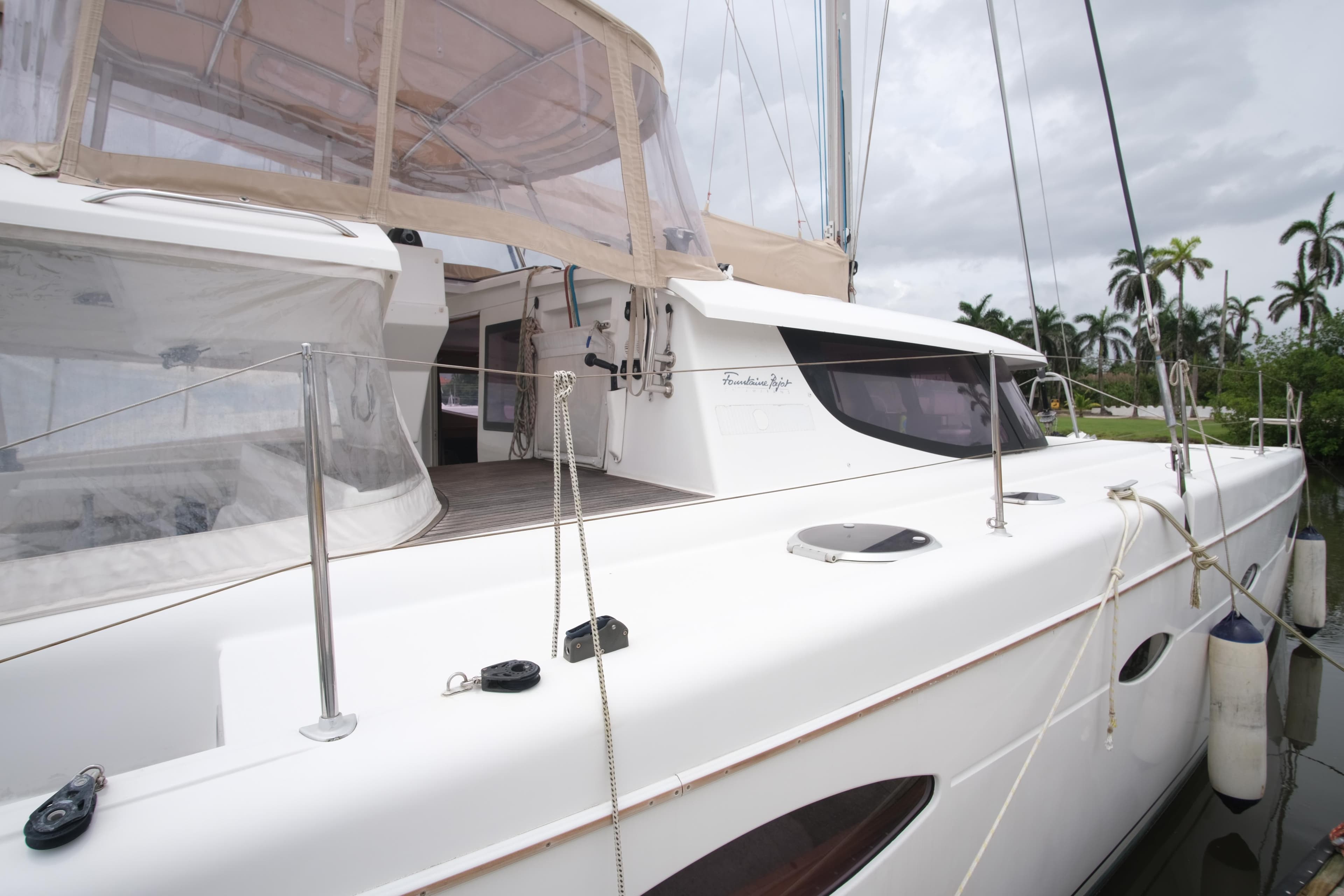 Fountaine Pajot Salina 48 Evolution Maestro 2011 catamaran docked, featuring sleek design and spacious deck.