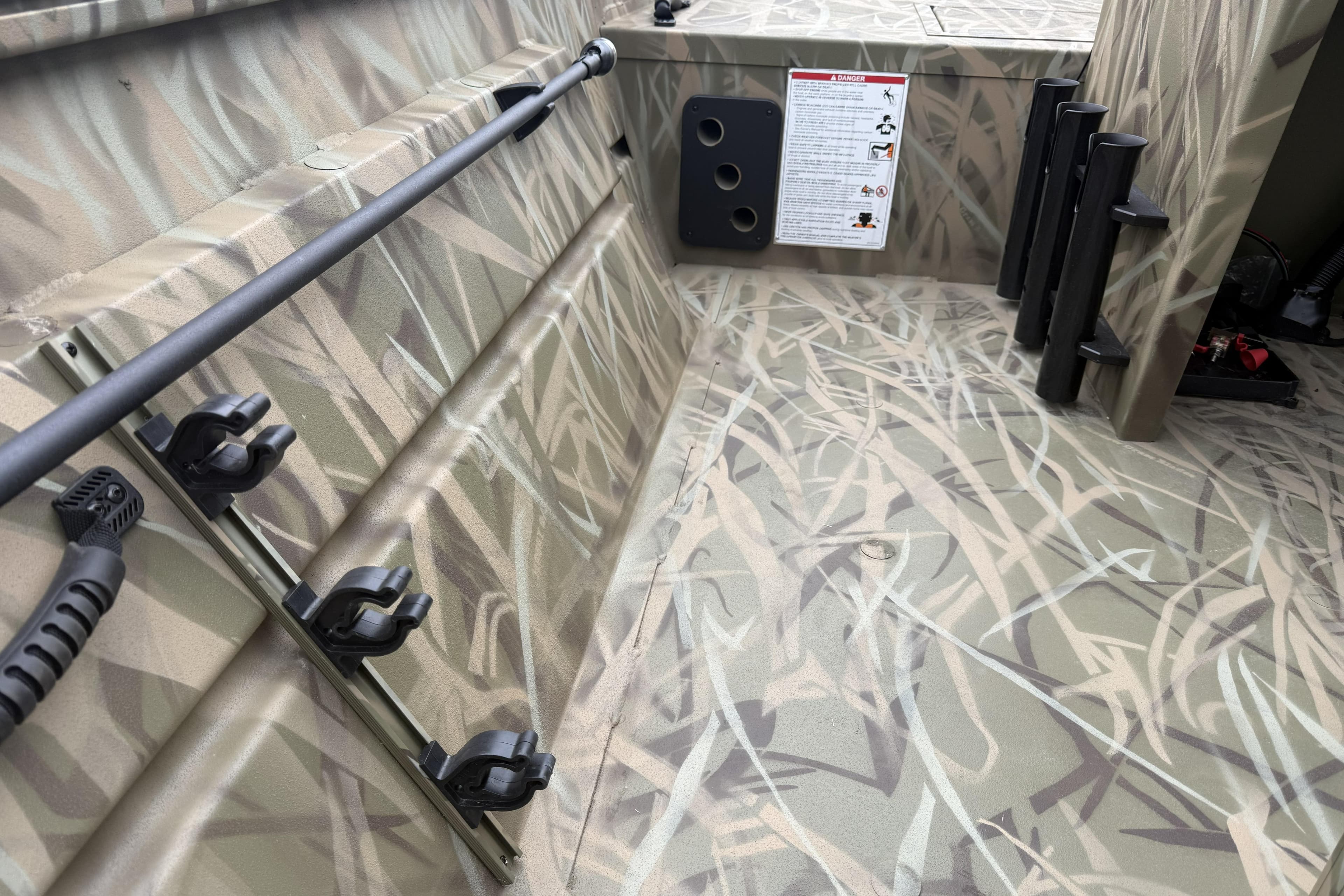 2026 Crestliner 1870 Retriever FCC interior with camouflage design and rod holders.