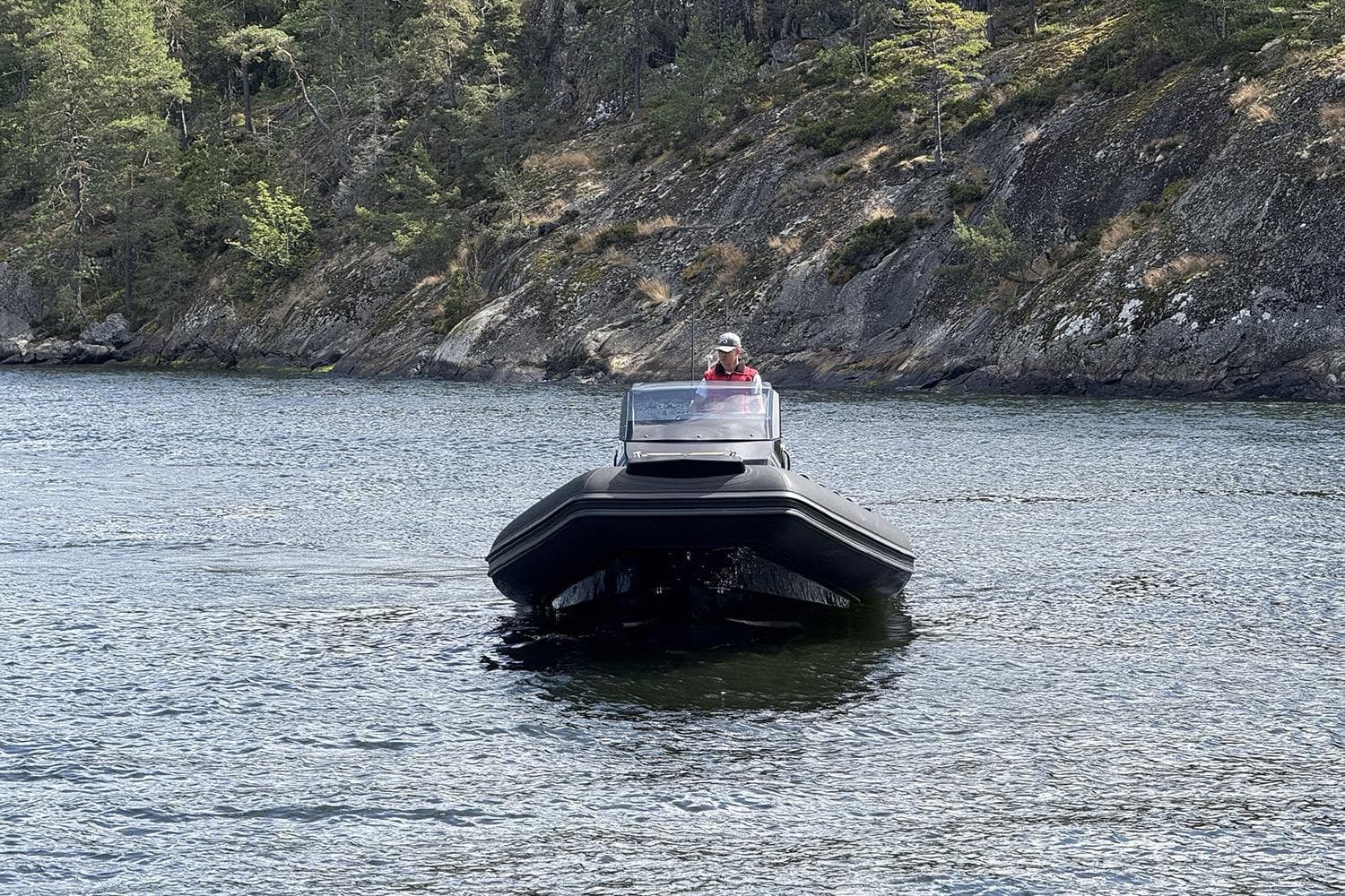 2025 Brig Eagle 10 boat navigating a scenic, forested waterway.