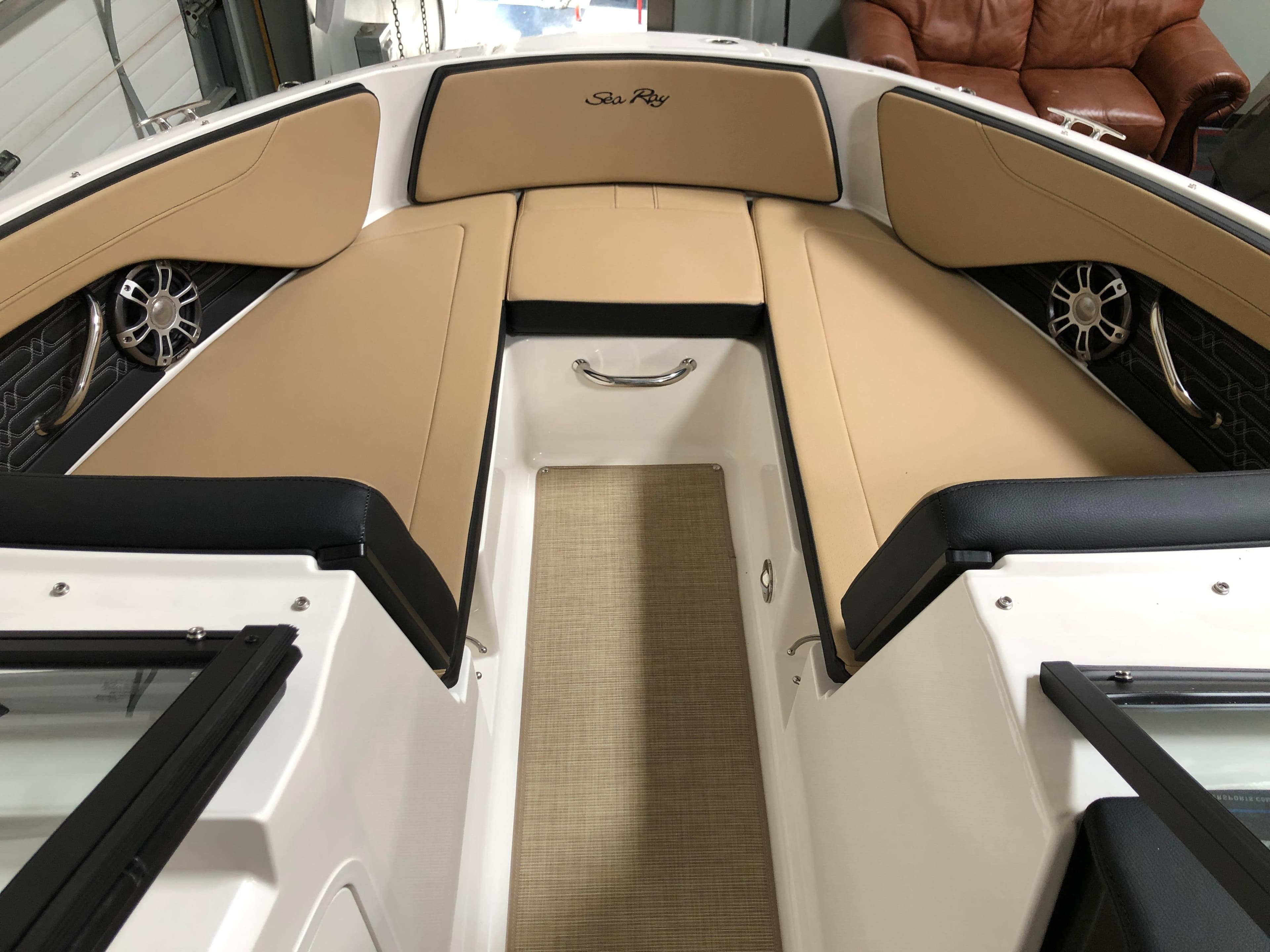 2025 Sea Ray SPX 210 boat interior with tan seating and modern design.