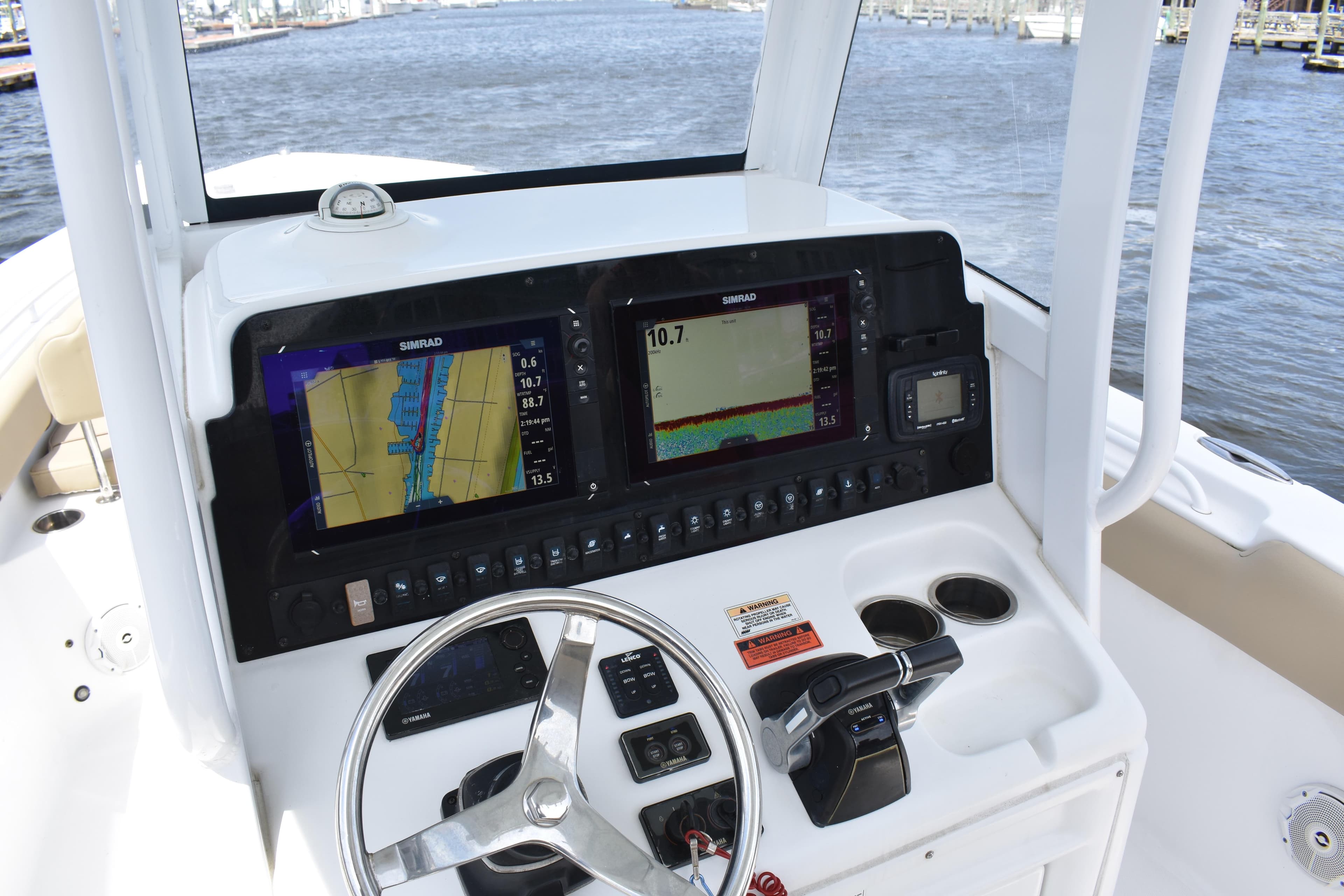 2017 Sea Hunt Gamefish 27 dashboard with navigation screens and steering wheel.