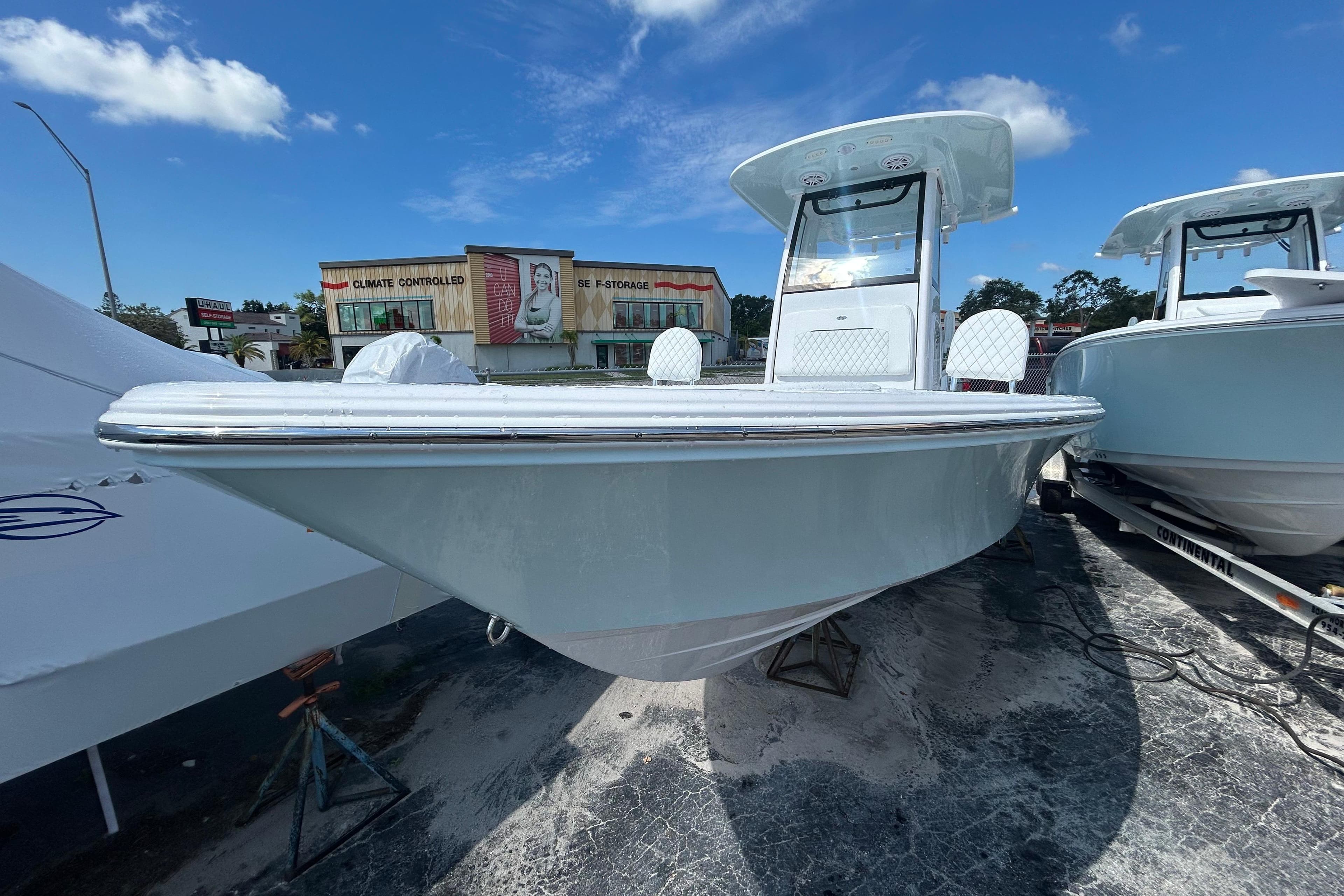 2025 Sportsman Masters 227 Bay Boat displayed outdoors under a clear blue sky.