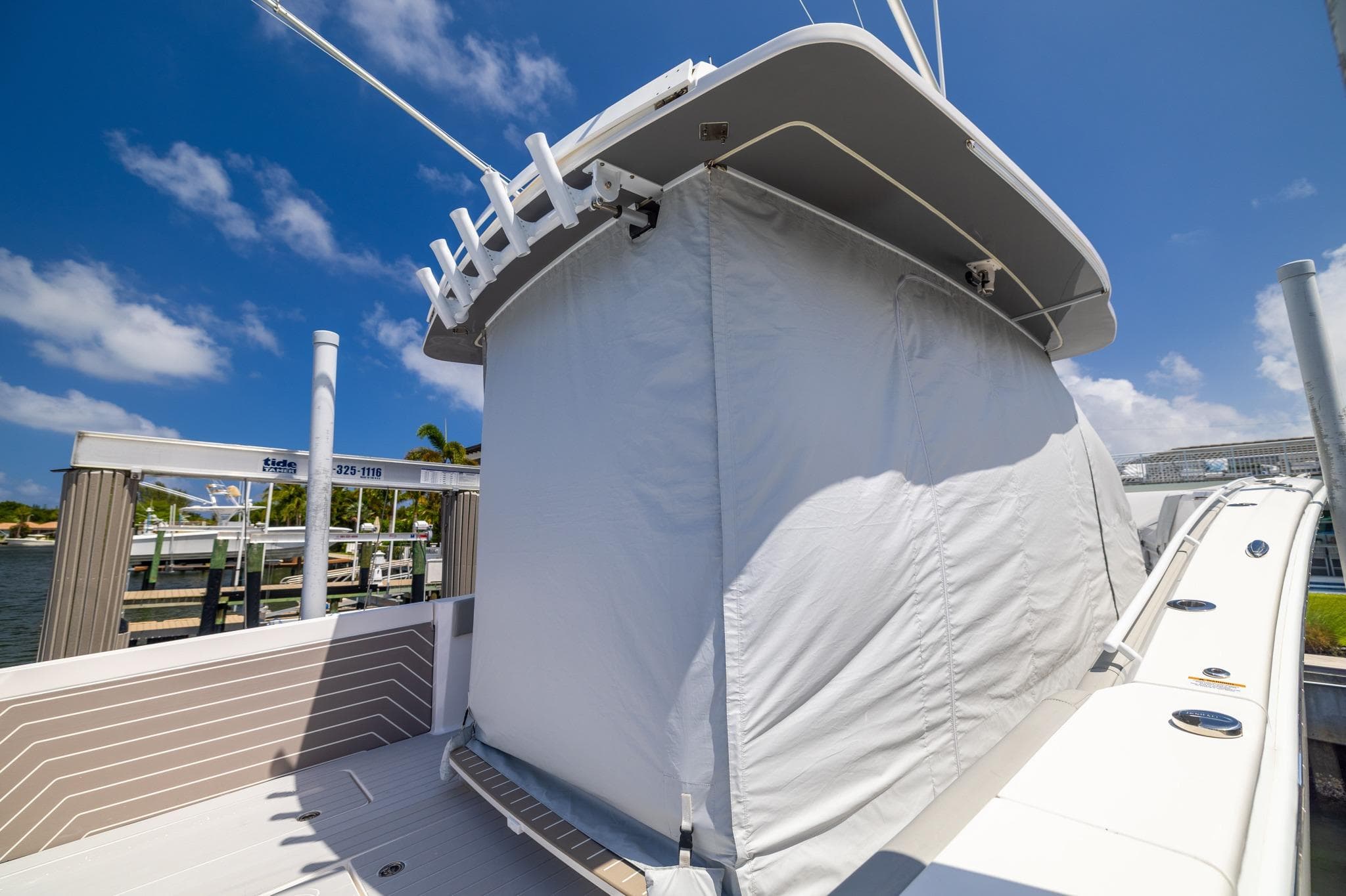 2024 Scout 400 LXF boat with covered deck, docked under a clear blue sky.