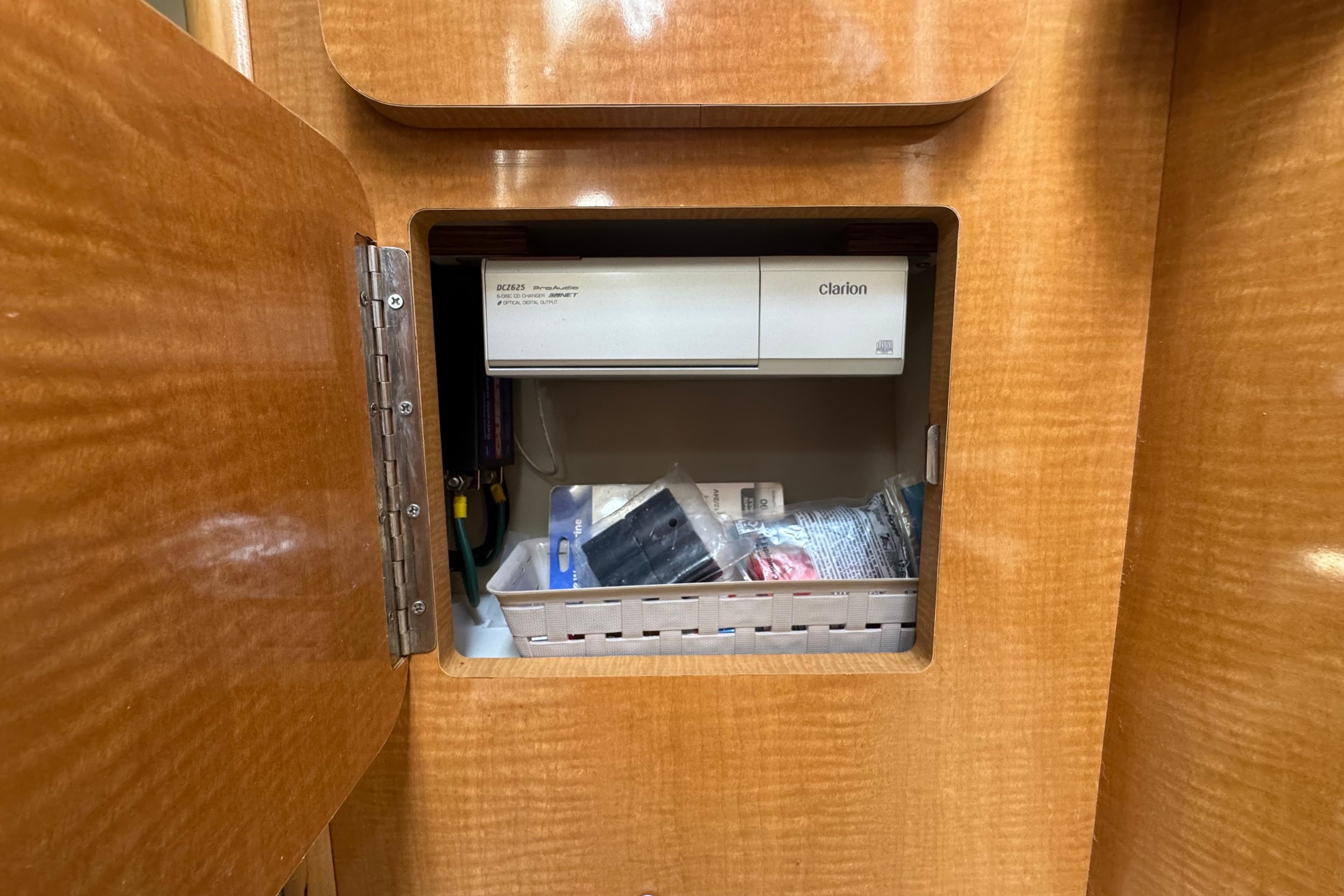 Wooden cabinet interior with Clarion stereo system in a 2008 Larson Cabrio 260 boat.
