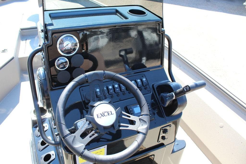 2026 Excel Bay Pro Elite 230 boat dashboard with steering wheel and controls.