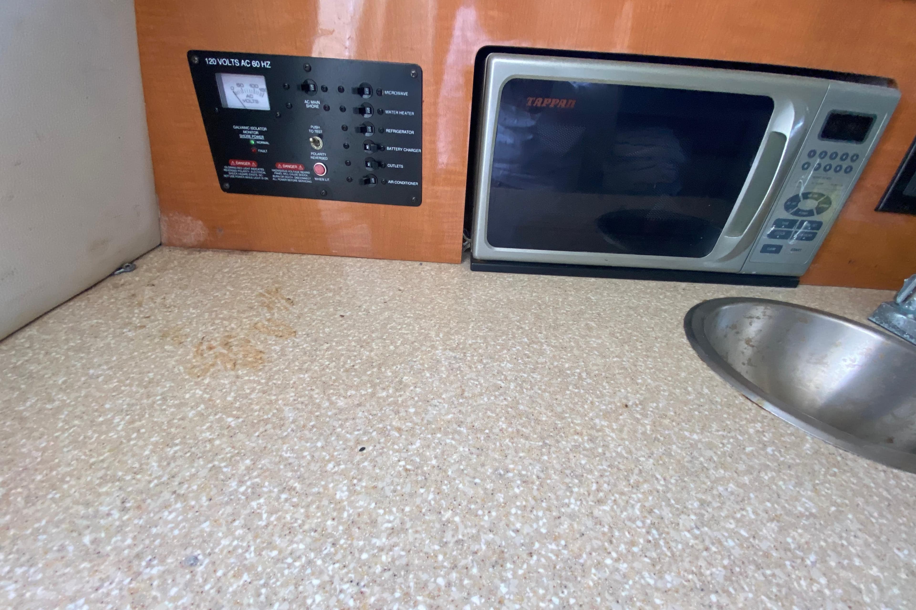 2007 Robalo R265 Walkaround interior with microwave, sink, and control panel.
