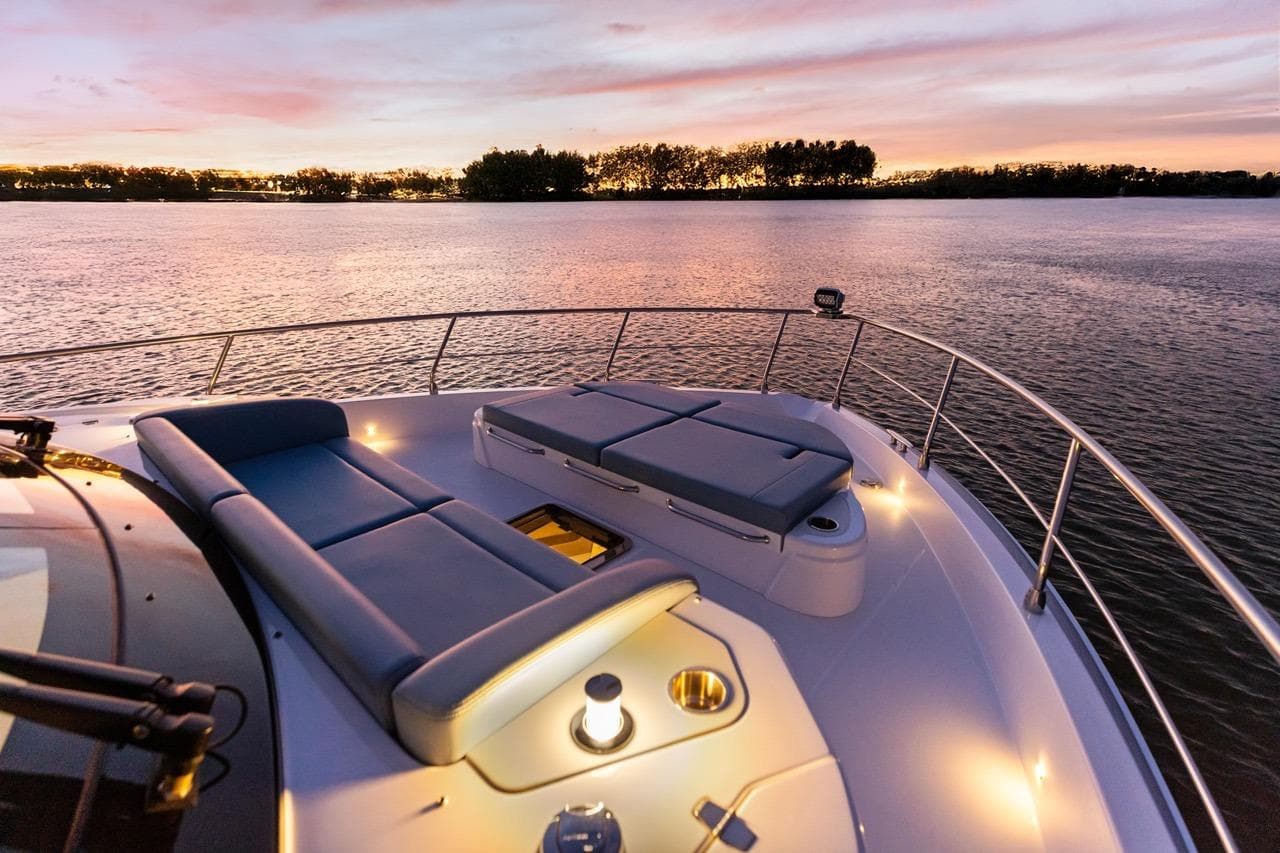 Luxurious 2026 Cruisers Yachts 50 Fly at sunset, featuring elegant deck seating.
