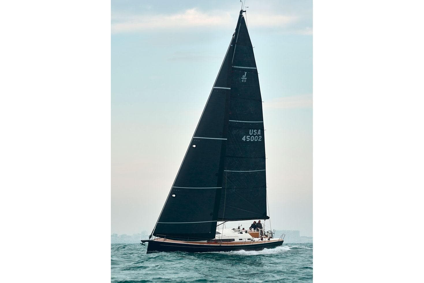 2026 J Boats J/45 sailing on open water with sleek black sails.