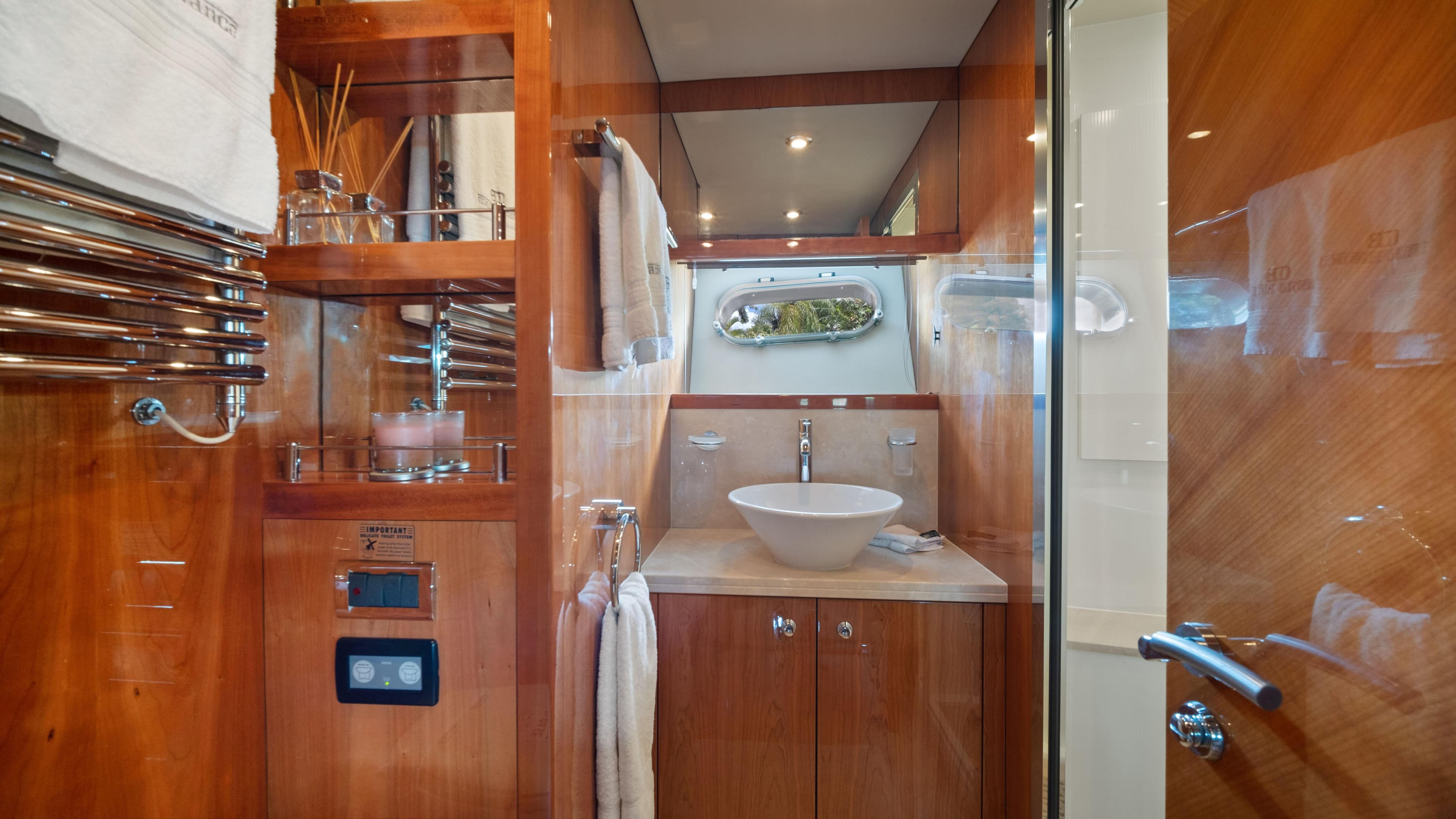 Luxurious bathroom in 2007 Sunseeker Predator 108 yacht with wooden cabinetry and modern fixtures.