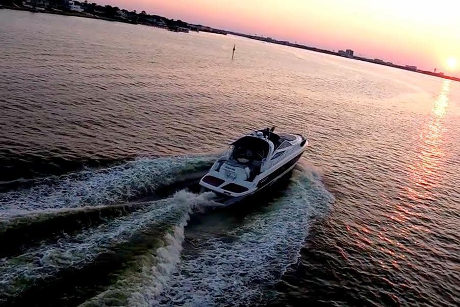 2008 Cranchi Mediterranee 43 yacht cruising at sunset on open water.