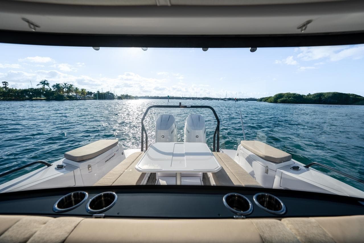 2026 Axopar 37 XC Cross Cabin boat with scenic ocean view and sunny sky.