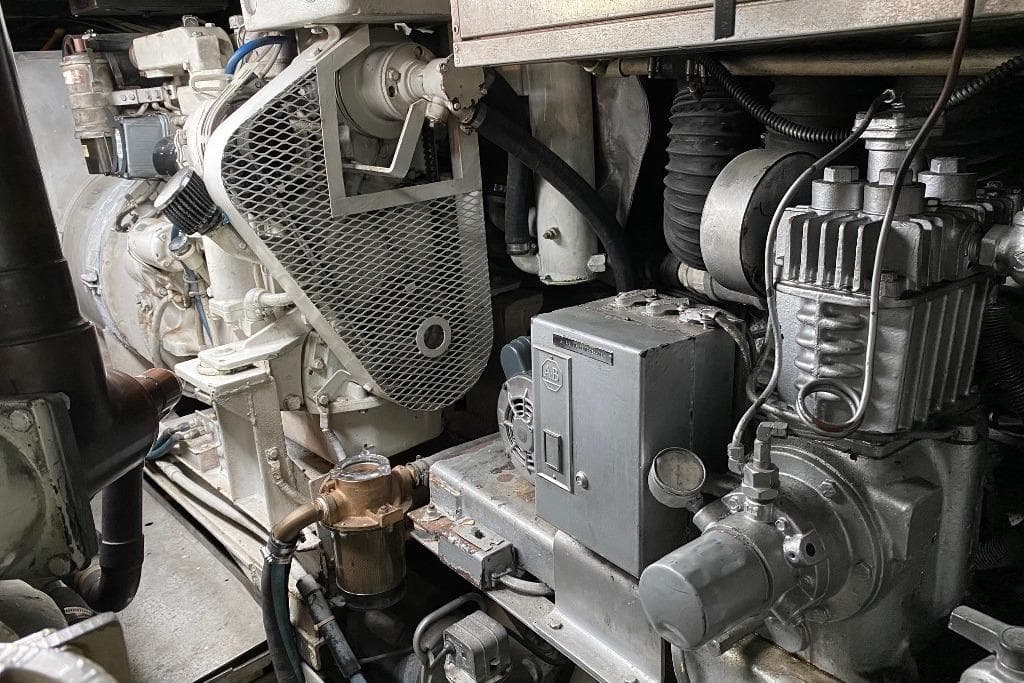 Engine room of a 1988 Burger 80 Motor Yacht, showcasing mechanical components and machinery.