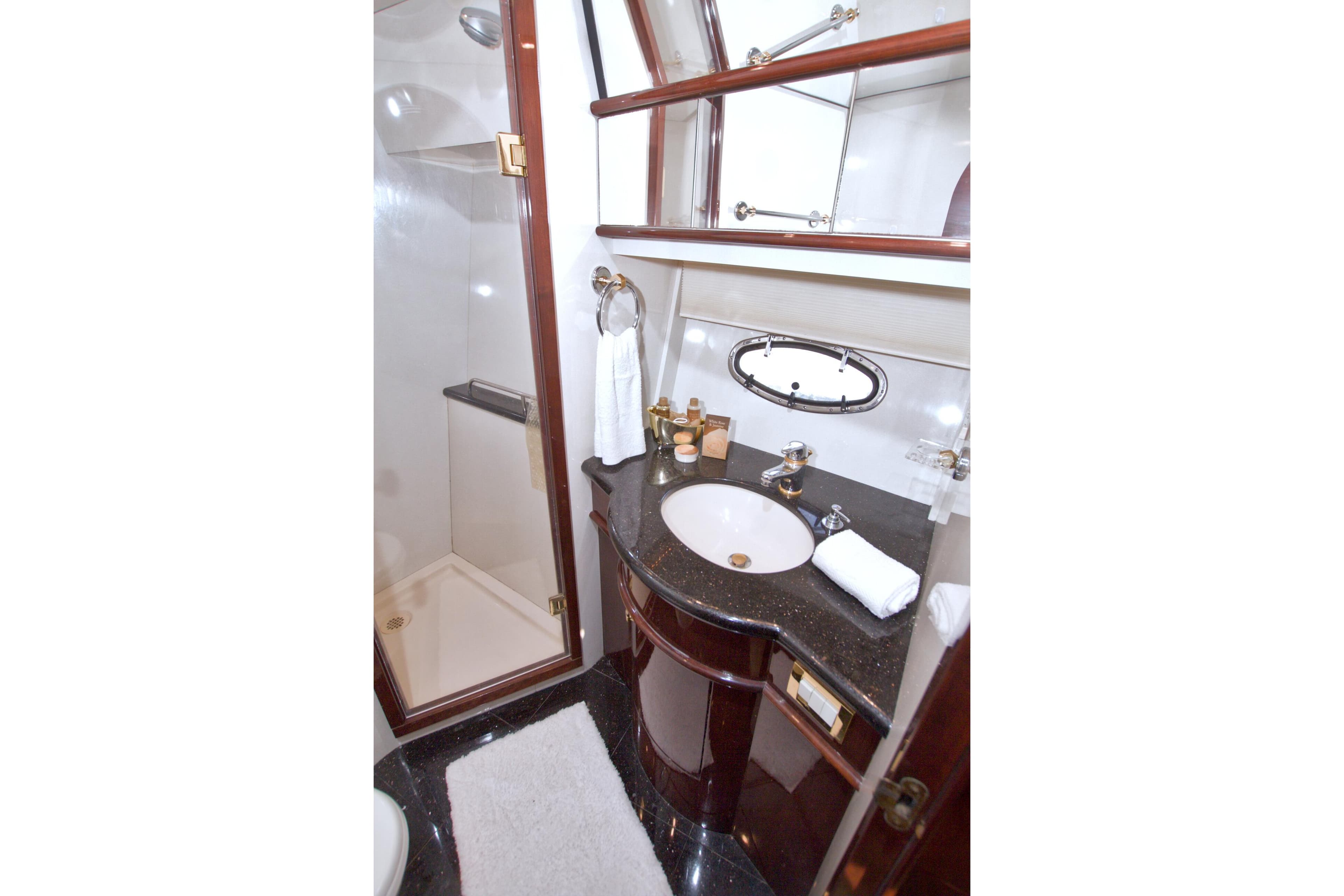 Luxurious bathroom in 2005 Neptunus 62 Flybridge yacht with elegant fixtures and shower.
