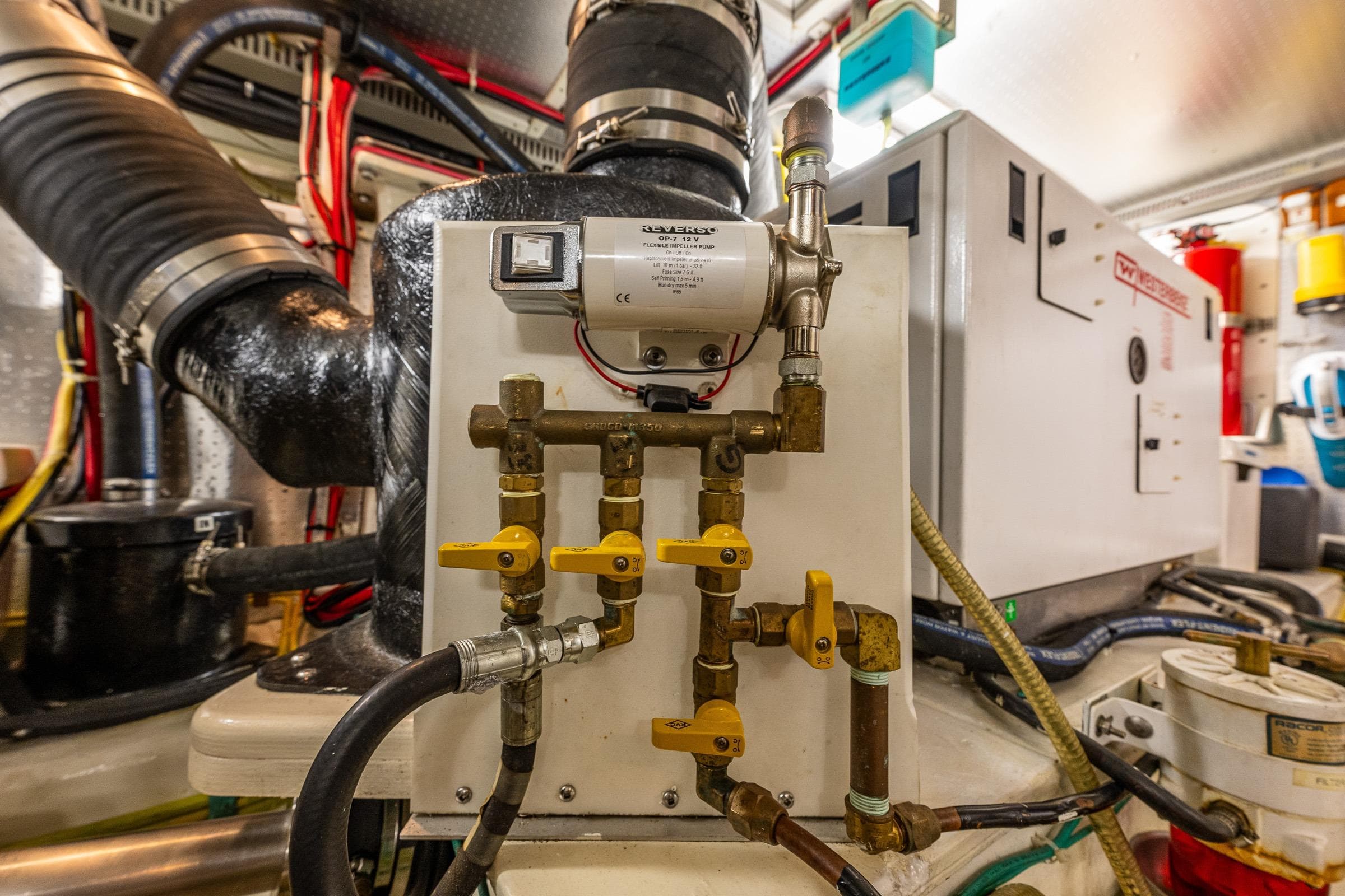 Engine room of 2007 DeFever 56 yacht with complex piping and machinery.