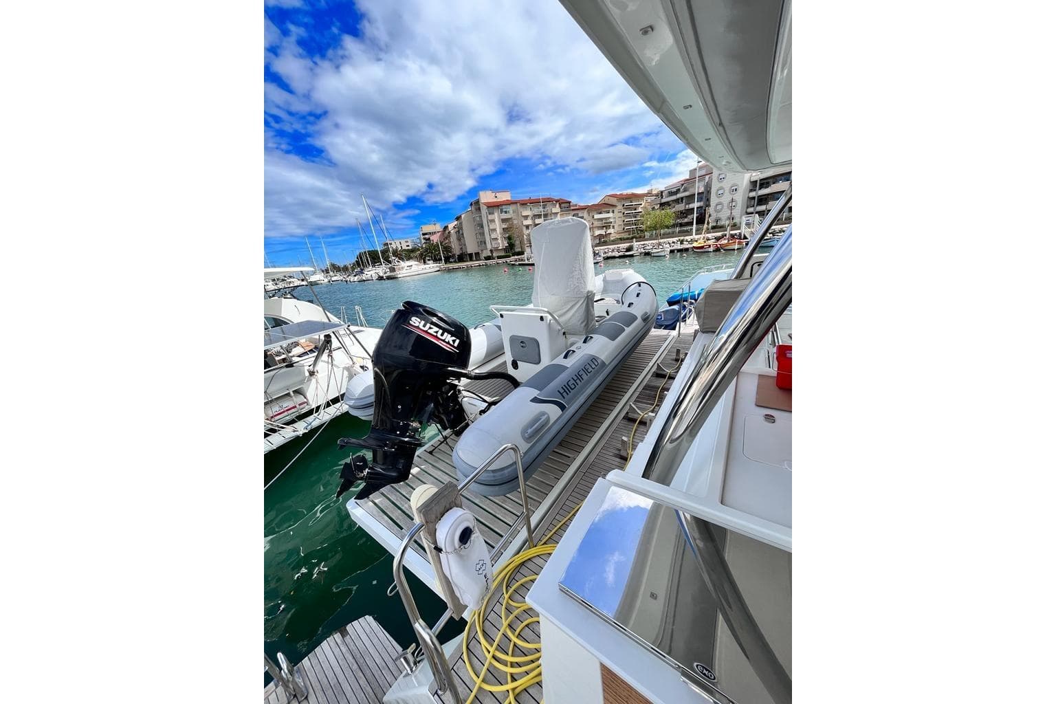 2021 Fountaine Pajot Catamaran Alegria 67 with Suzuki outboard motor in marina.