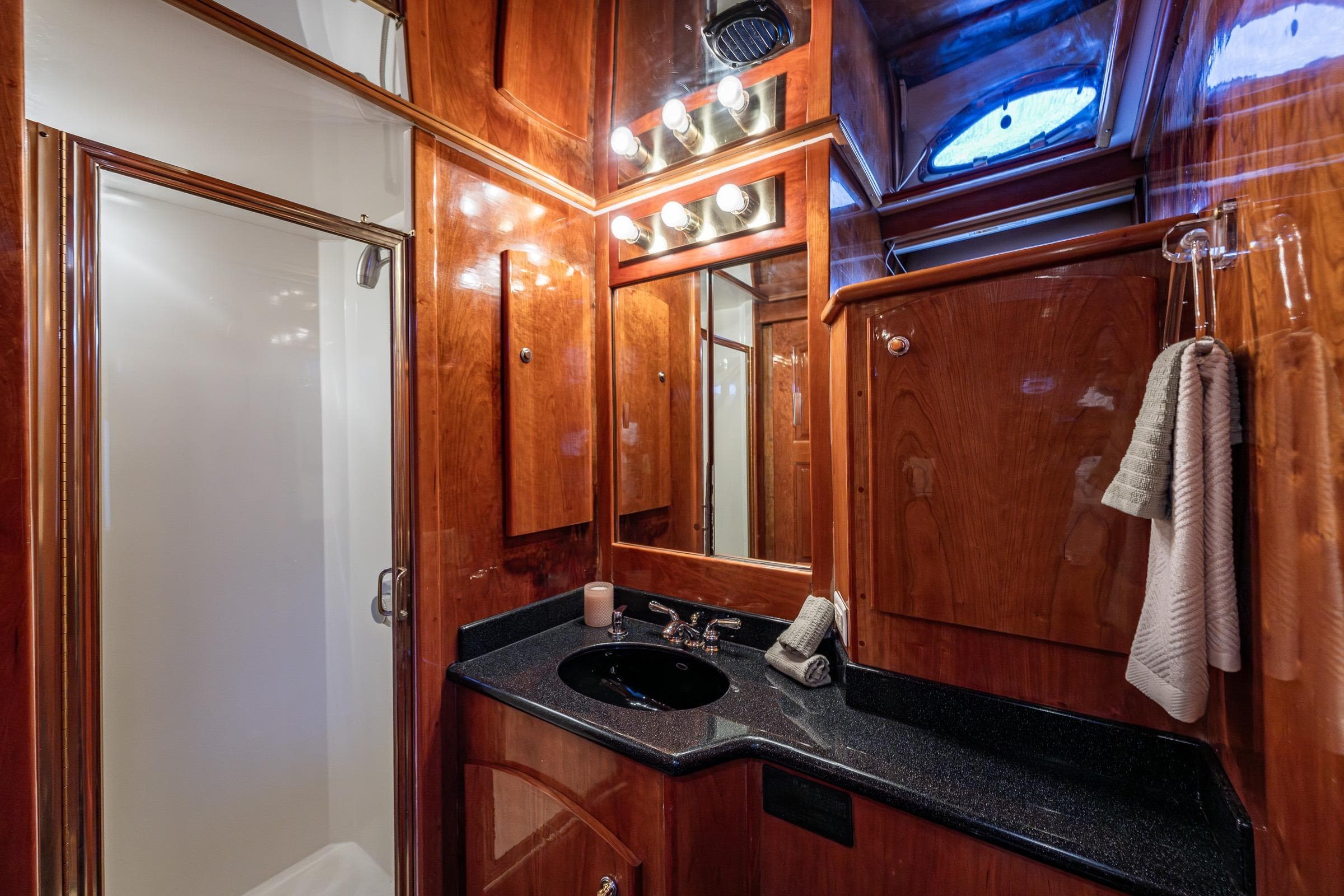 Luxurious 2001 Navigator Pilothouse yacht bathroom with wood paneling and modern fixtures.