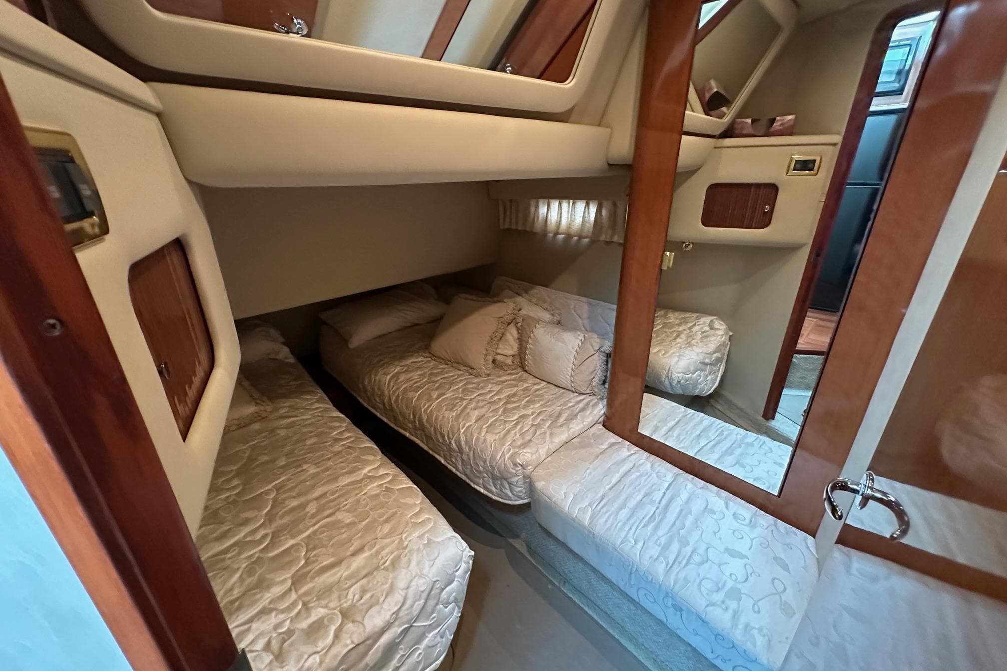 Interior cabin of 2002 Sea Ray 400 Sedan Bridge with twin beds and wood accents.