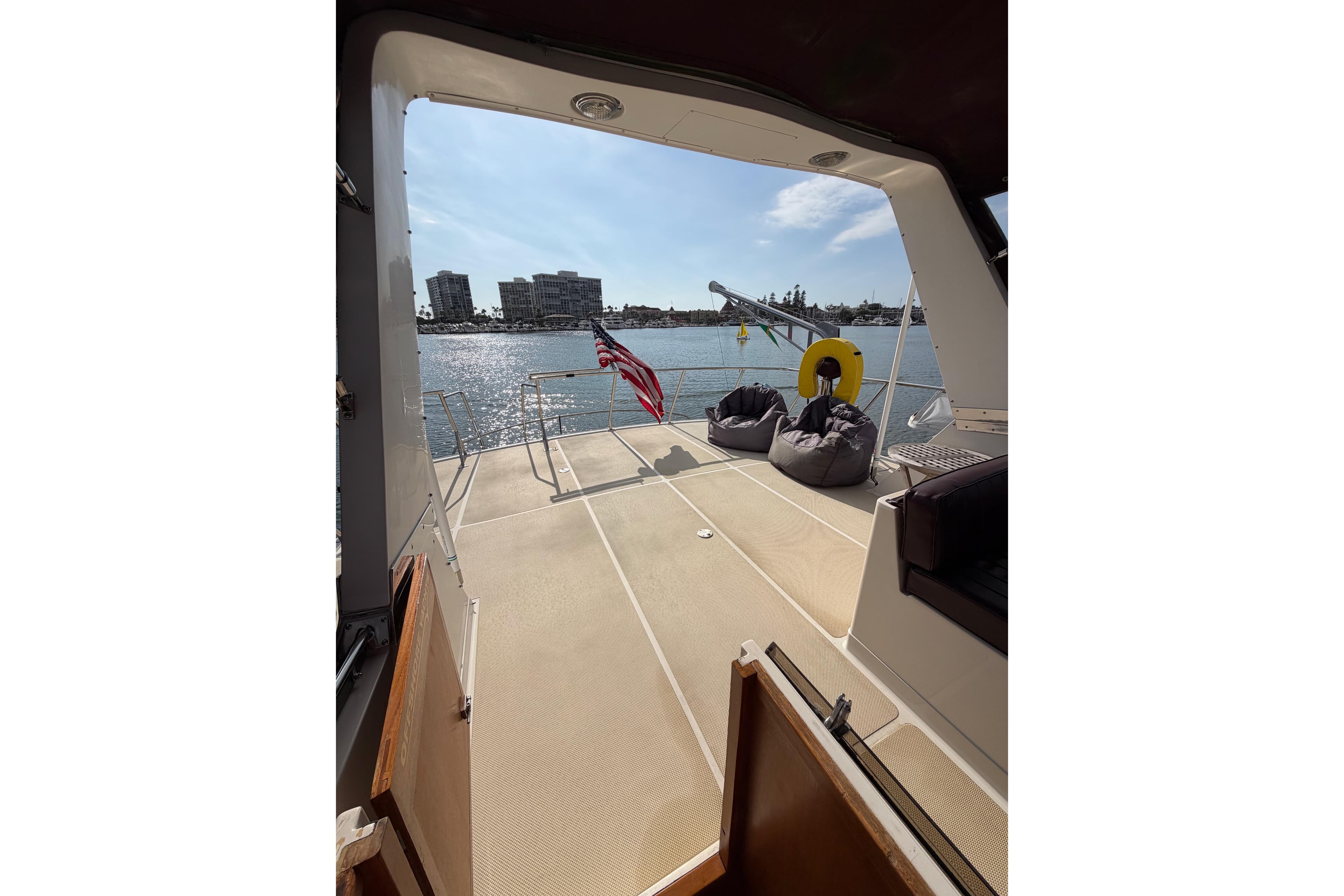 1988 Offshore Yachts 48 Sedan deck view with bean bags and American flag.