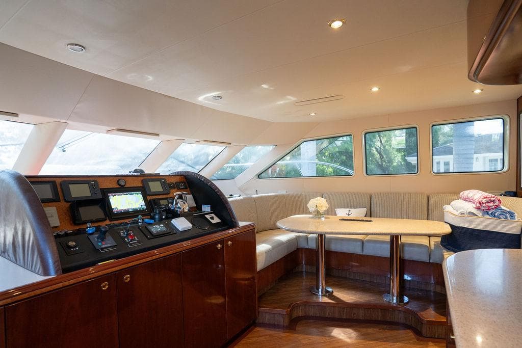 Luxurious interior of 2004 Cheoy Lee 84 Bravo Flybridge yacht with helm and seating area.