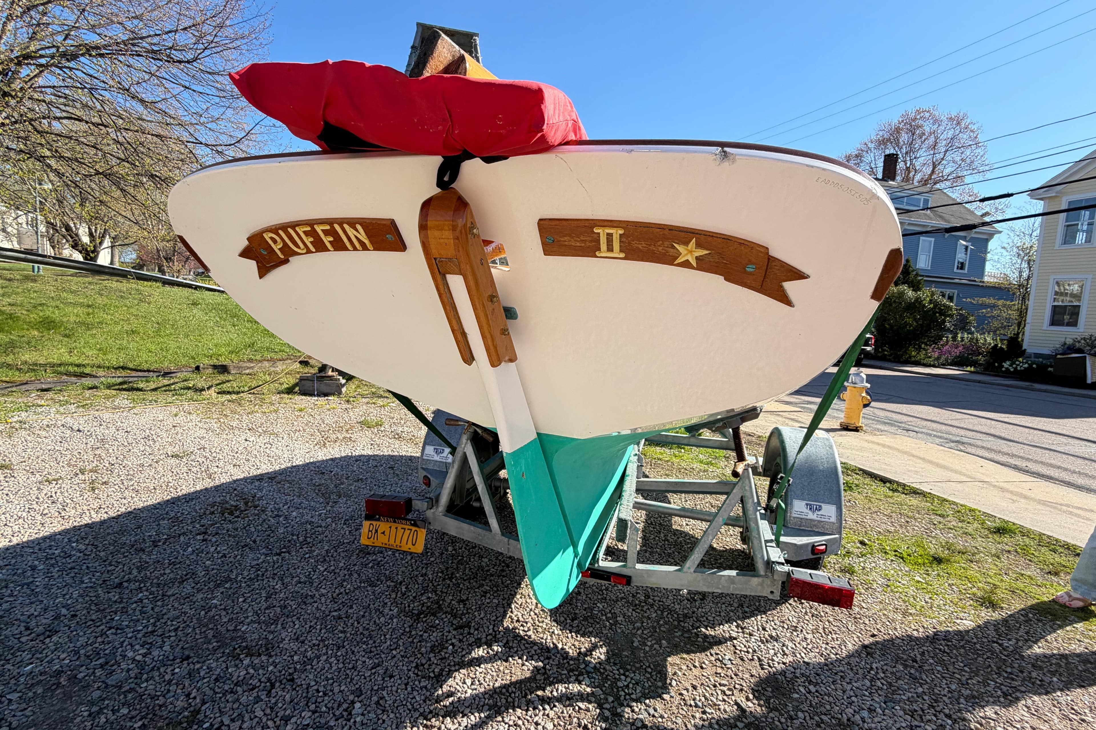 2005 Edey & Duff Doughdish sailboat "Puffin II" on trailer, parked outdoors.