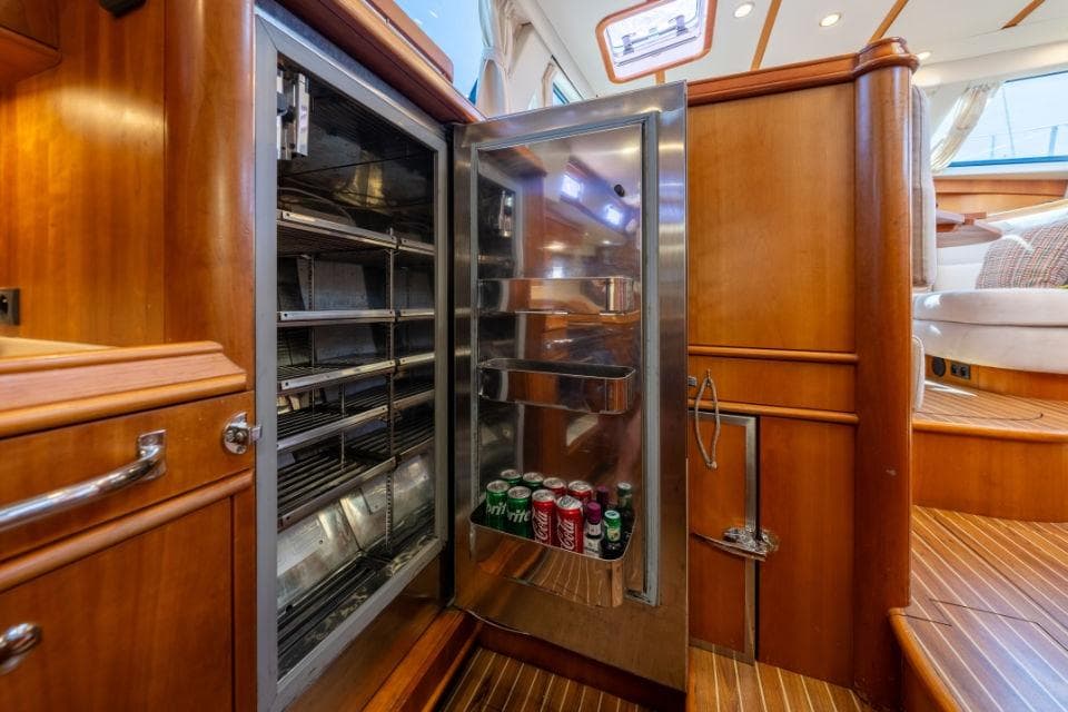 Open fridge with drinks inside a 2008 Discovery 55 yacht interior.
