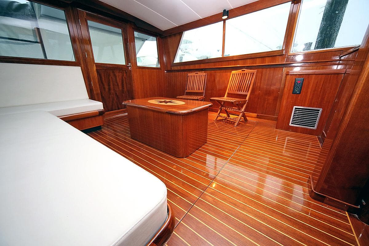 Interior of 1971 Hatteras 45 Convertible yacht with wooden furnishings and seating.