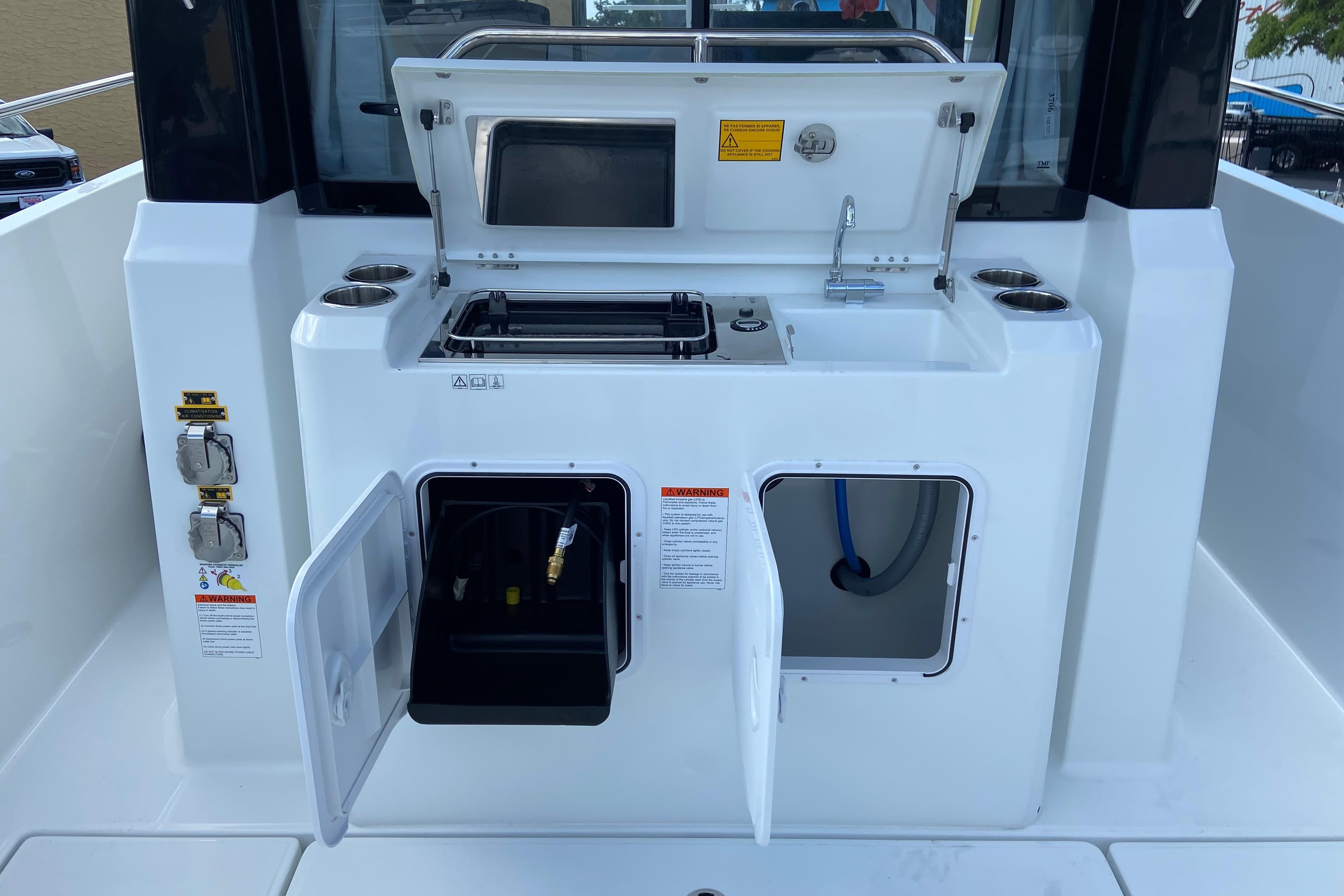 2026 Jeanneau NC Sport 795 Series 2 boat galley with sink and storage compartments.