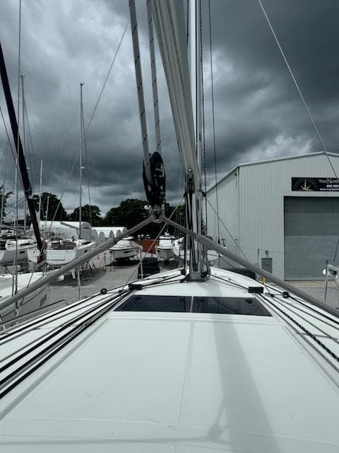 2024 Jeanneau Sun Odyssey 410 sailboat docked under cloudy skies.
