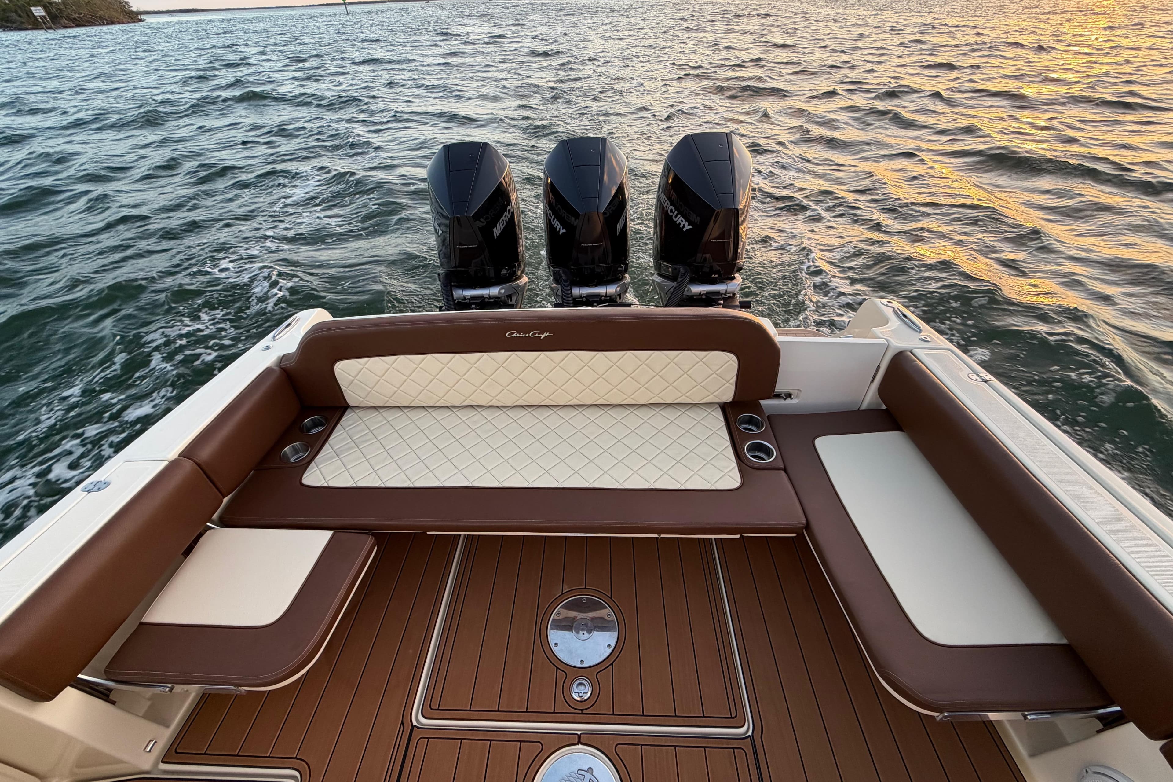 2021 Chris-Craft Catalina 34 boat with triple Mercury engines on water at sunset.