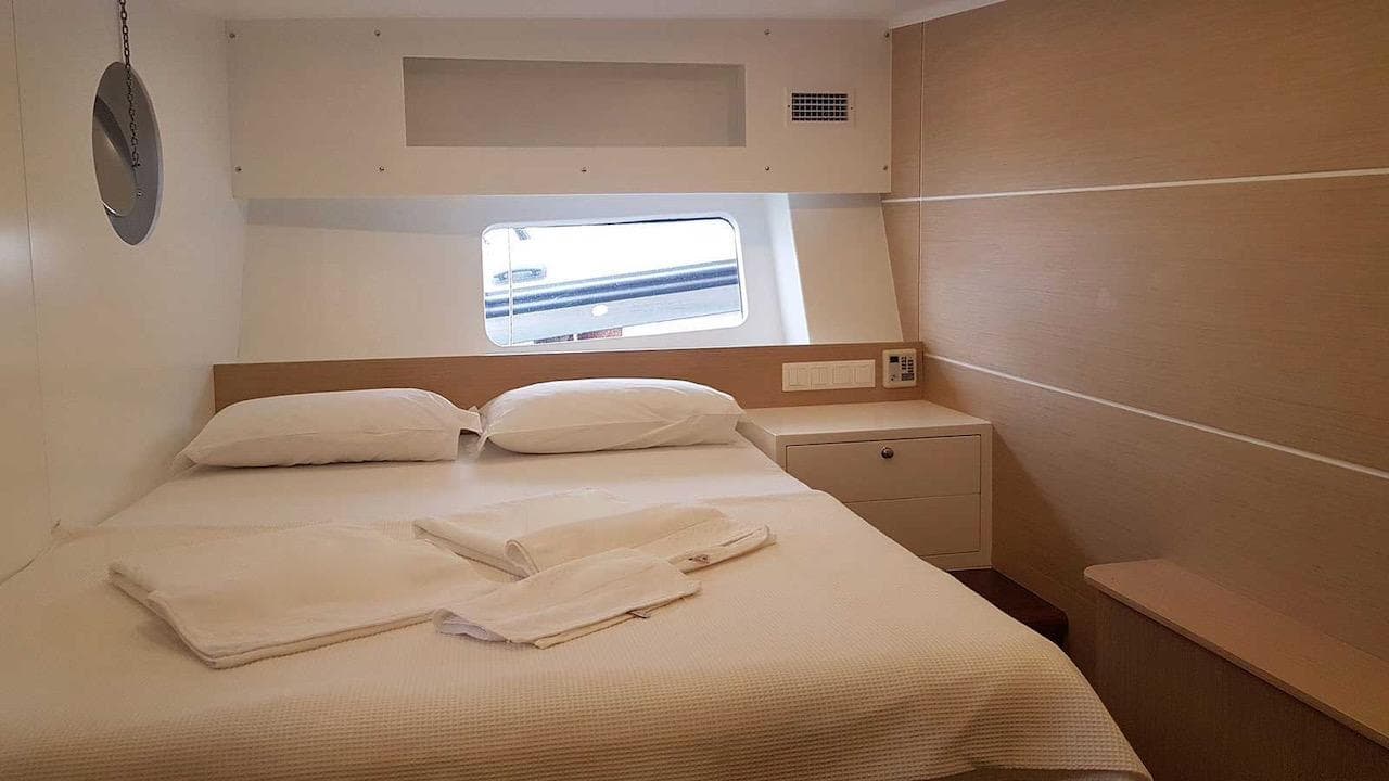 Cozy cabin interior on 2017 Custom GULET yacht with bed and window view.
