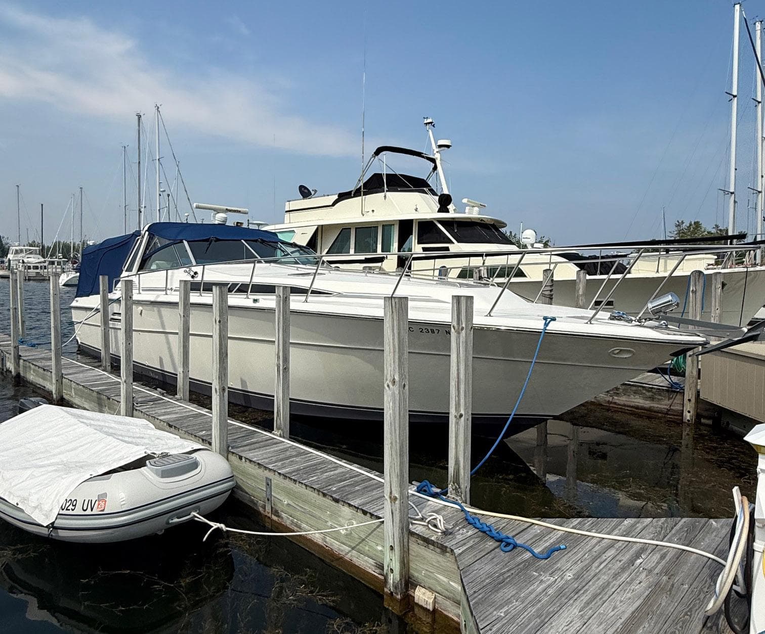 1989 Sea Ray 460 Express Cruiser docked at marina, clear sky background.