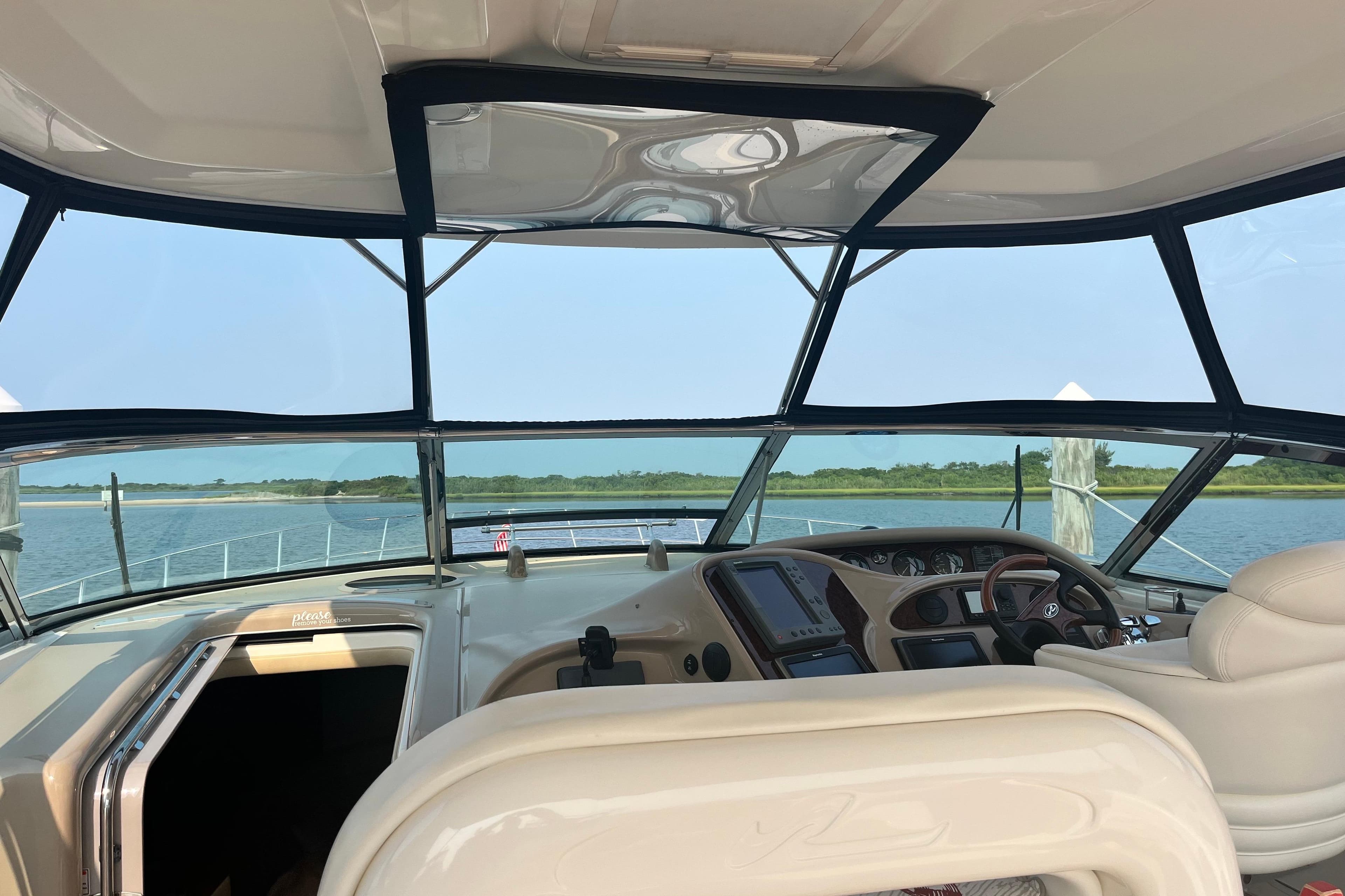Cockpit view of 2003 Sea Ray 550 Sundancer yacht on calm waters.