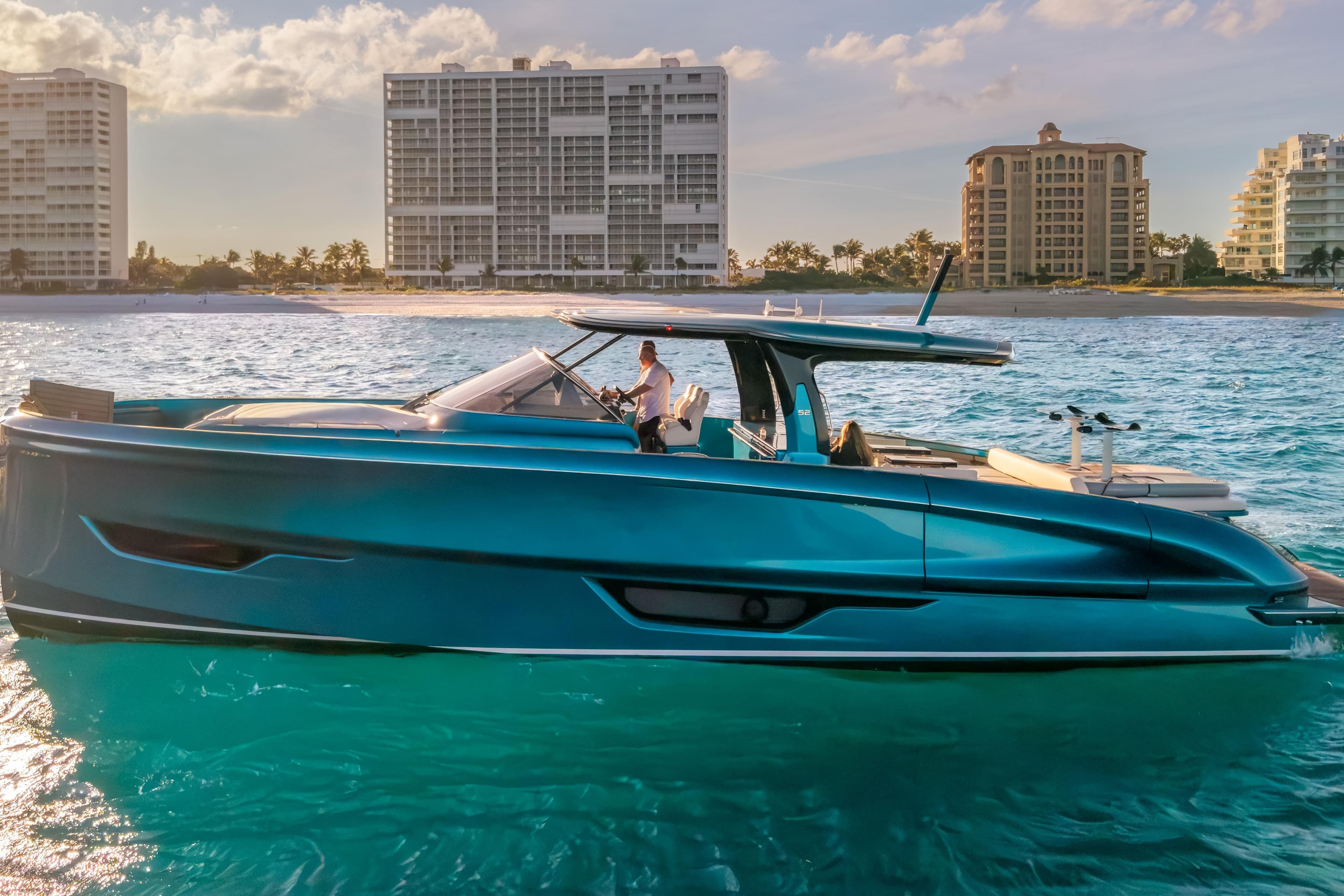 2024 Solaris Power 52 Open yacht cruising near a coastal city skyline.
