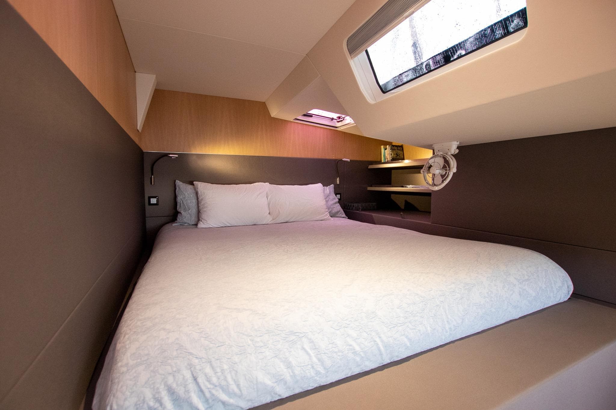 Luxurious cabin interior of 2022 Privilege 510 yacht with cozy bed and modern design.