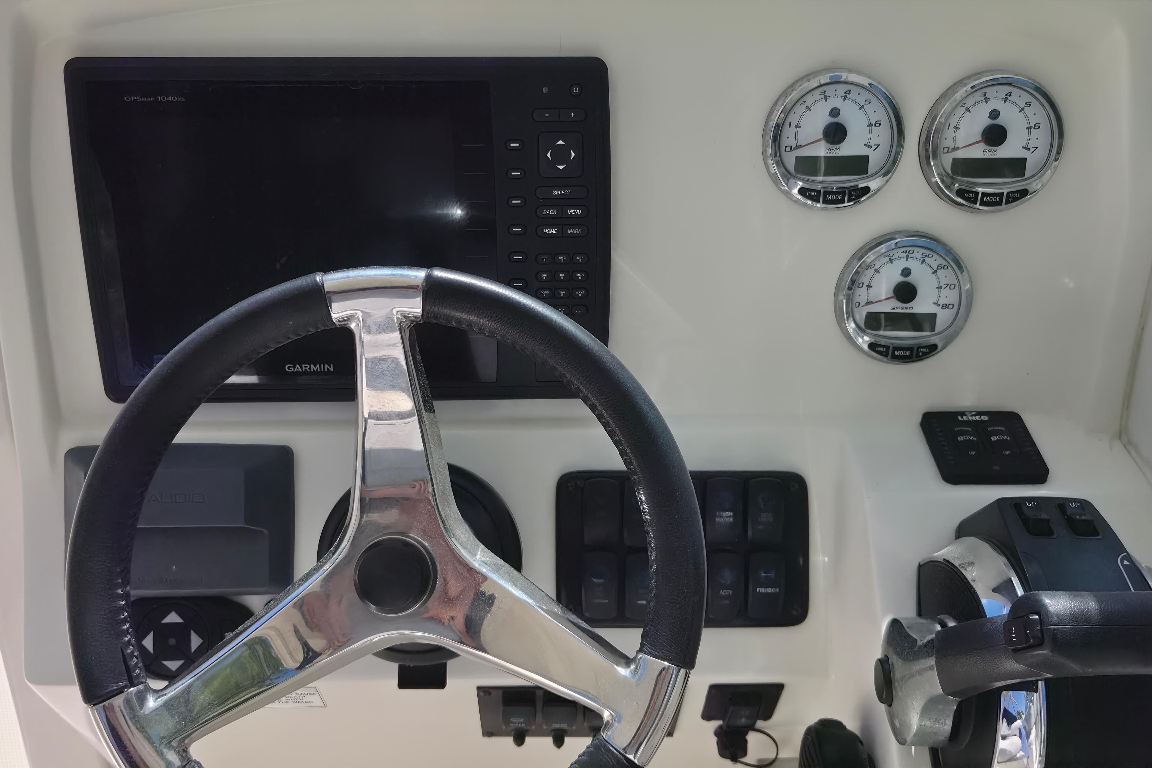 Steering wheel and dashboard of 2016 Sailfish 275 DC boat with Garmin display.