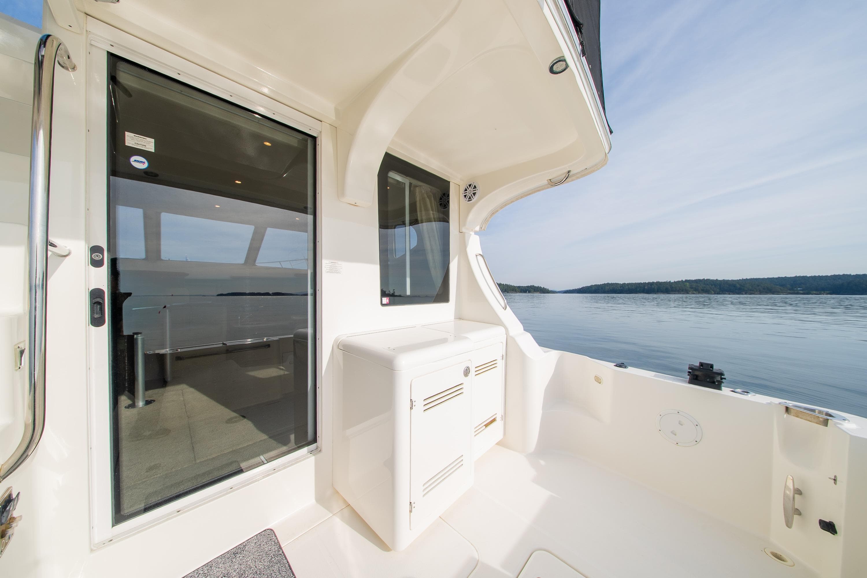 2005 Silverton 34 Convertible yacht deck with serene water view.