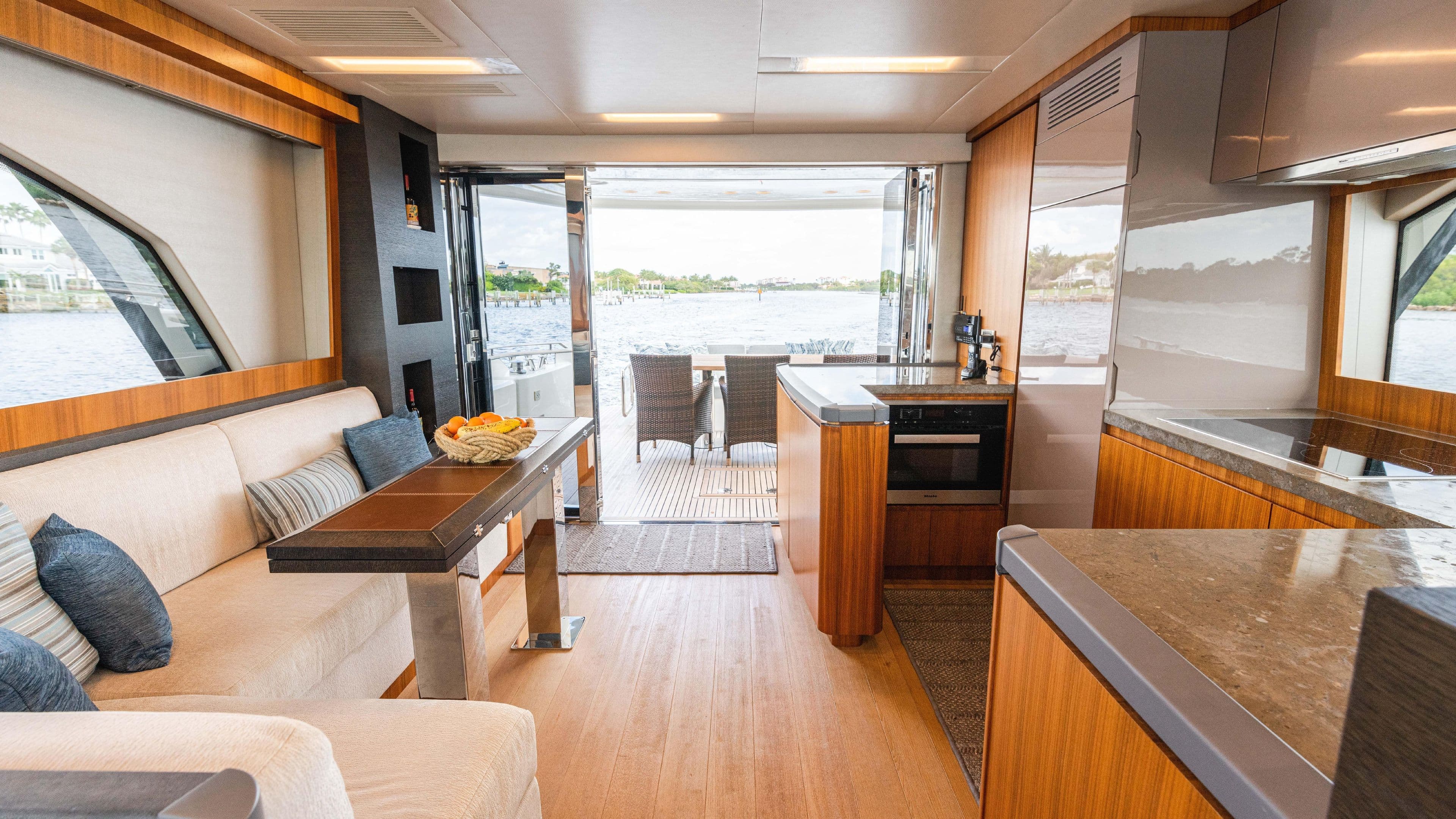 Luxurious interior of 2016 Monte Carlo Yachts MCY 65 with modern kitchen and seating area.