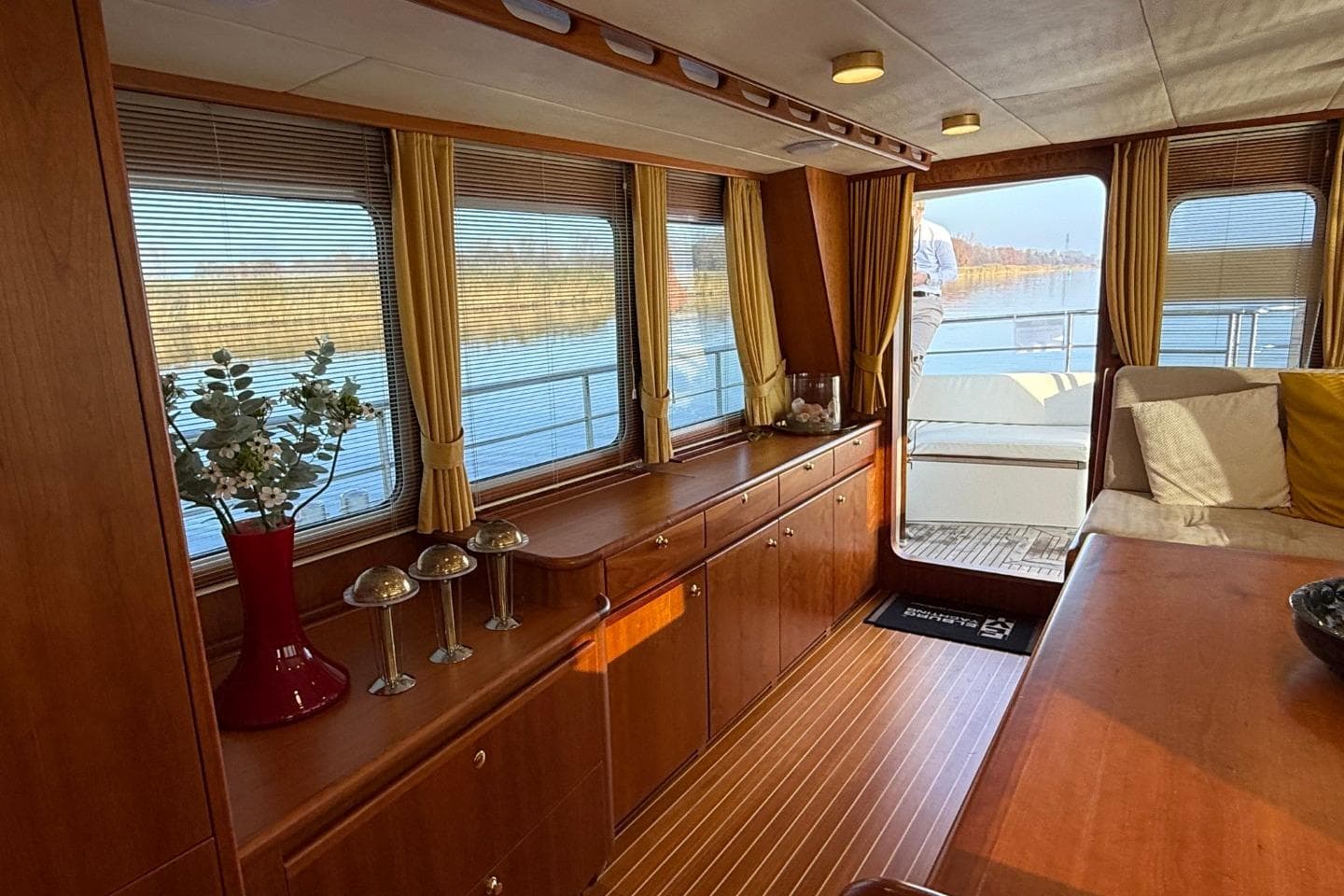 Luxurious interior of 2021 Altena Trawler 50 yacht with elegant wood finish and large windows.